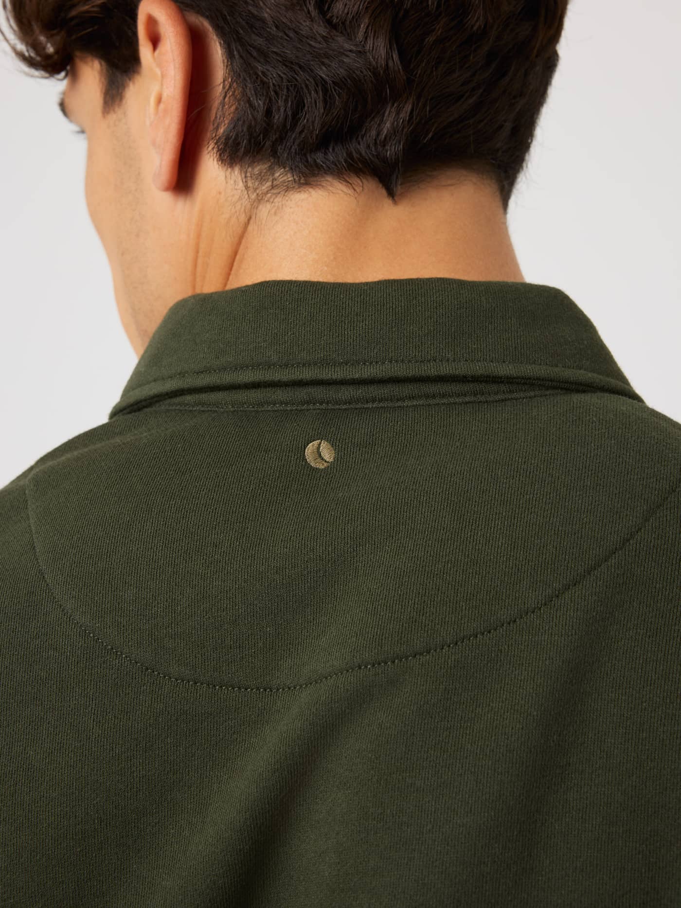 Back neck detail of the Borg Classic Polo Sweatshirt in Rosin (Green) with a small gold tennis ball embroidery. - Image 4