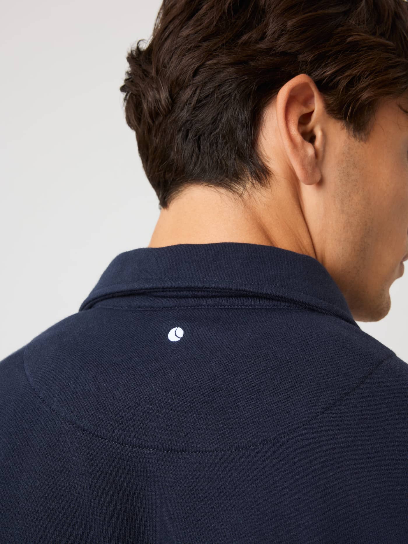 Borg Classic Polo Sweatshirt in Night sky (Navy) featuring a white tennis ball embroidery at the back neck. - Image 4