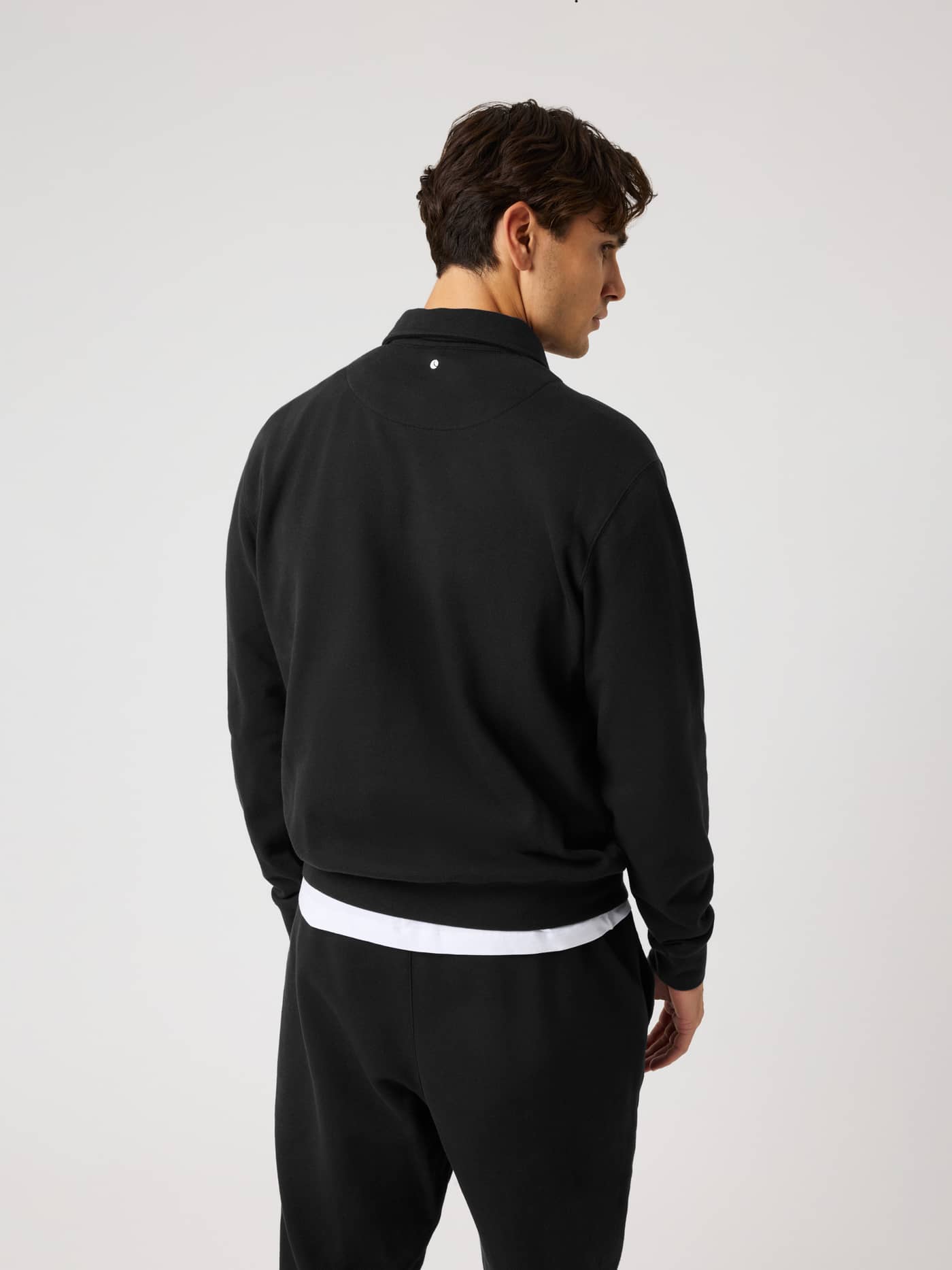 Back view of the Borg Classic Polo Sweatshirt in Black Beauty (Black) with a white tennis ball detail for training. - Image 2