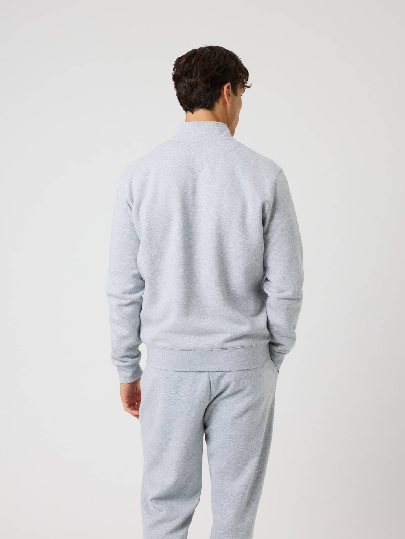 Back view of a man wearing the Björn Borg Centre Full Zip Sweatshirt in Light Grey Melange (Grey) with ribbed cuffs. - Image 2