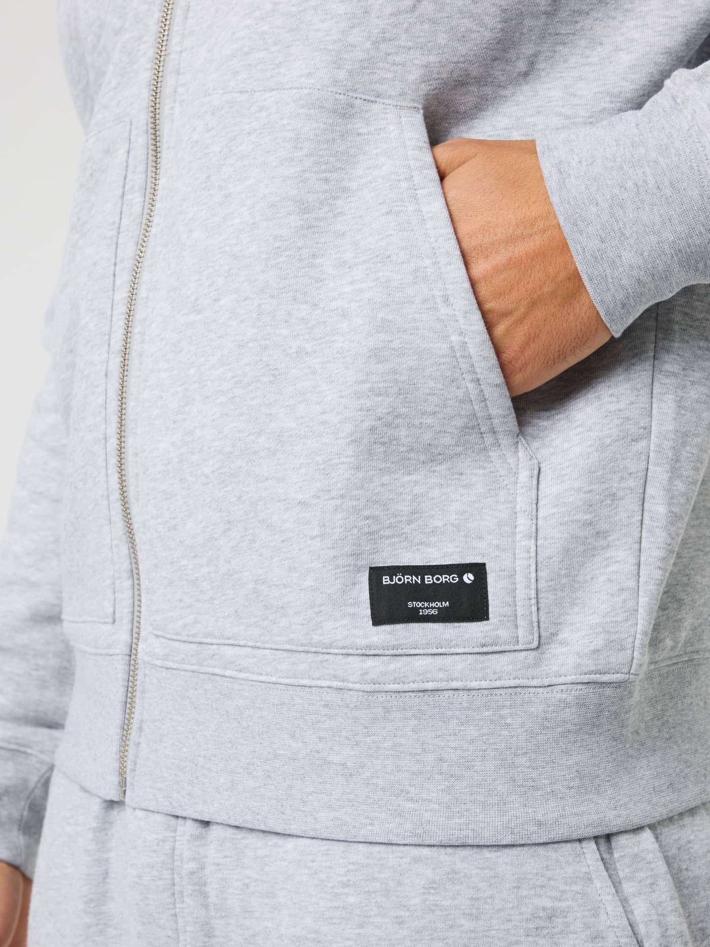 Centre Full Zip Sweatshirt in Light Grey Melange (Grey) featuring a front pocket and a black logo label. - Image 5
