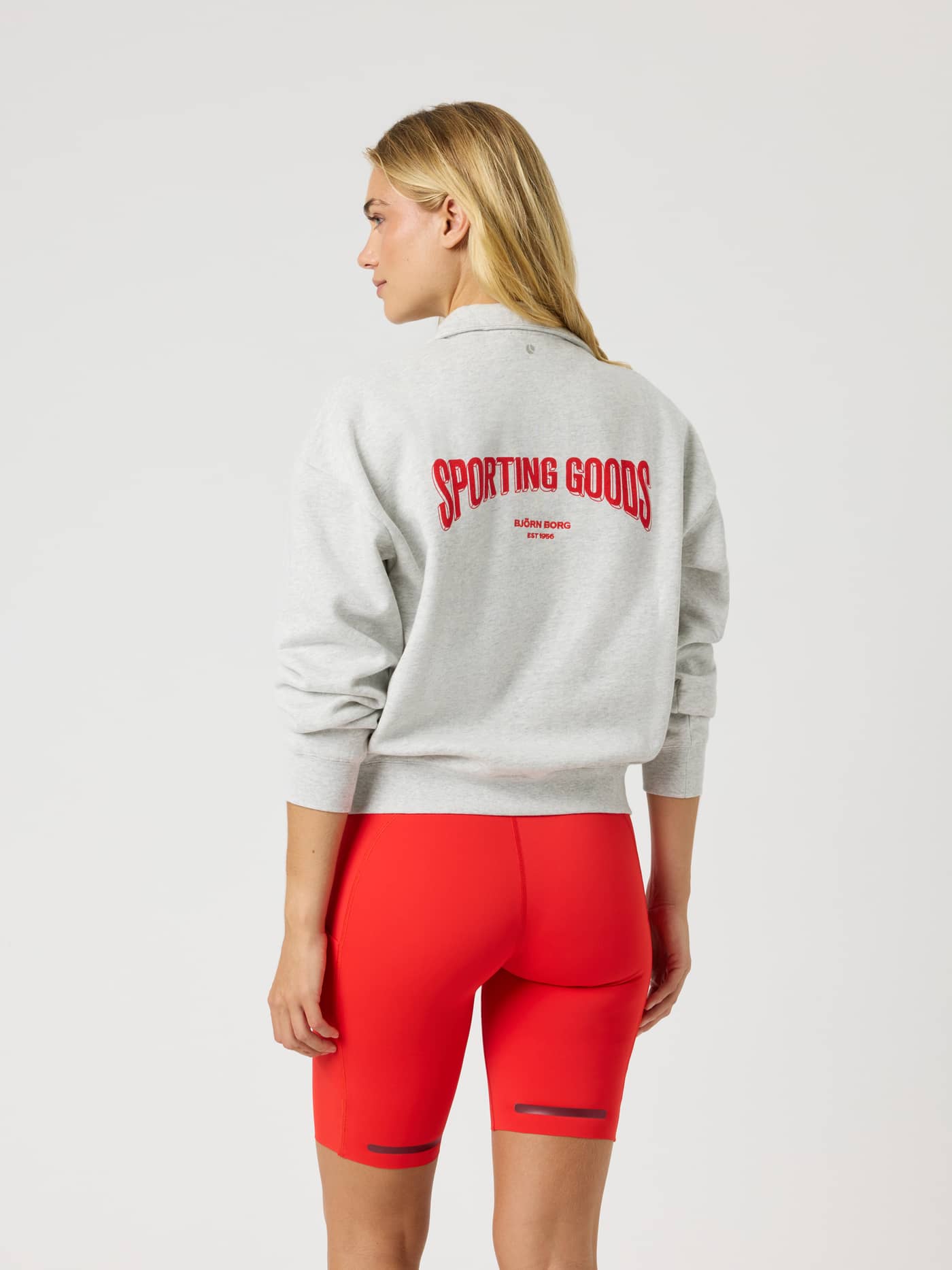 Back view of the Borg Halfzip Sweatshirt in Ultra Light Grey Melange (Grey) with a red Sporting Goods tennis graphic. - Image 3