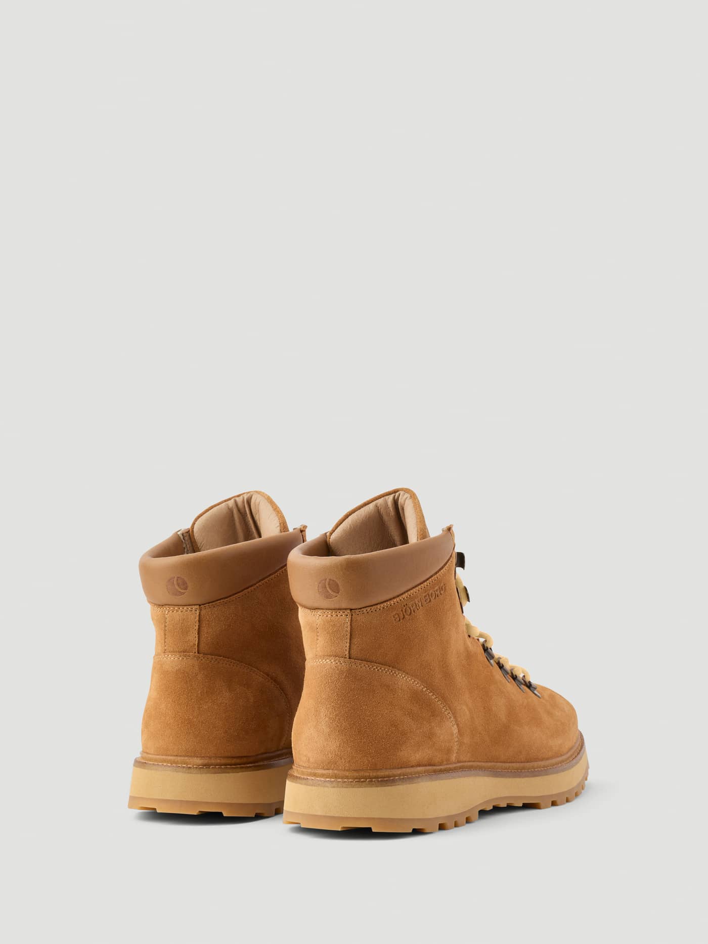 Back view of the Men's Summit Boots in Brown, featuring premium leather and a durable outsole with tonal logo details. - Image 3