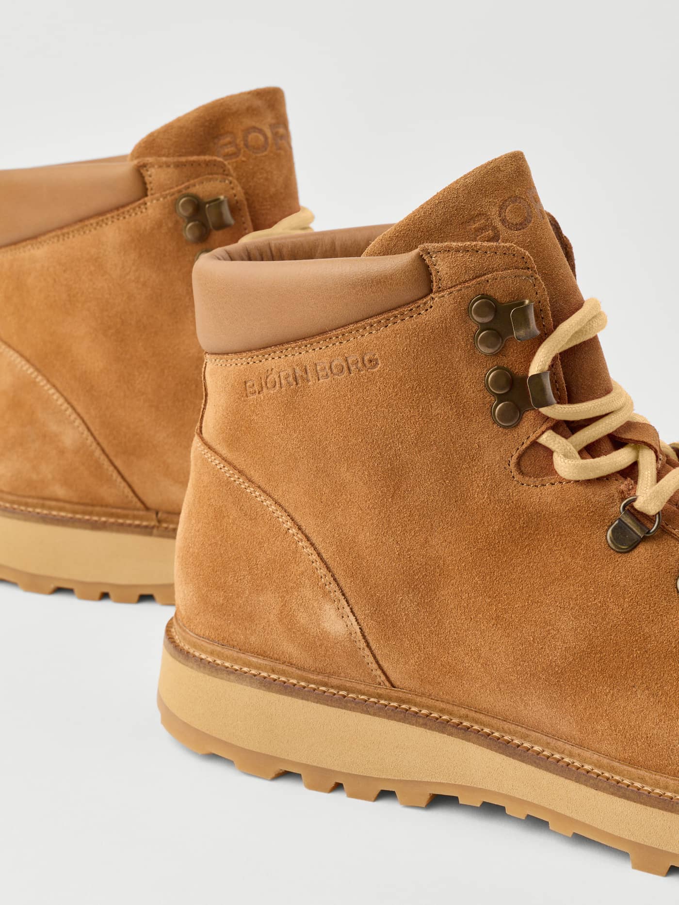 Close-up of the Men's Summit Boots in brown leather featuring a debossed Björn Borg logo and metal lacing eyelets. - Image 4