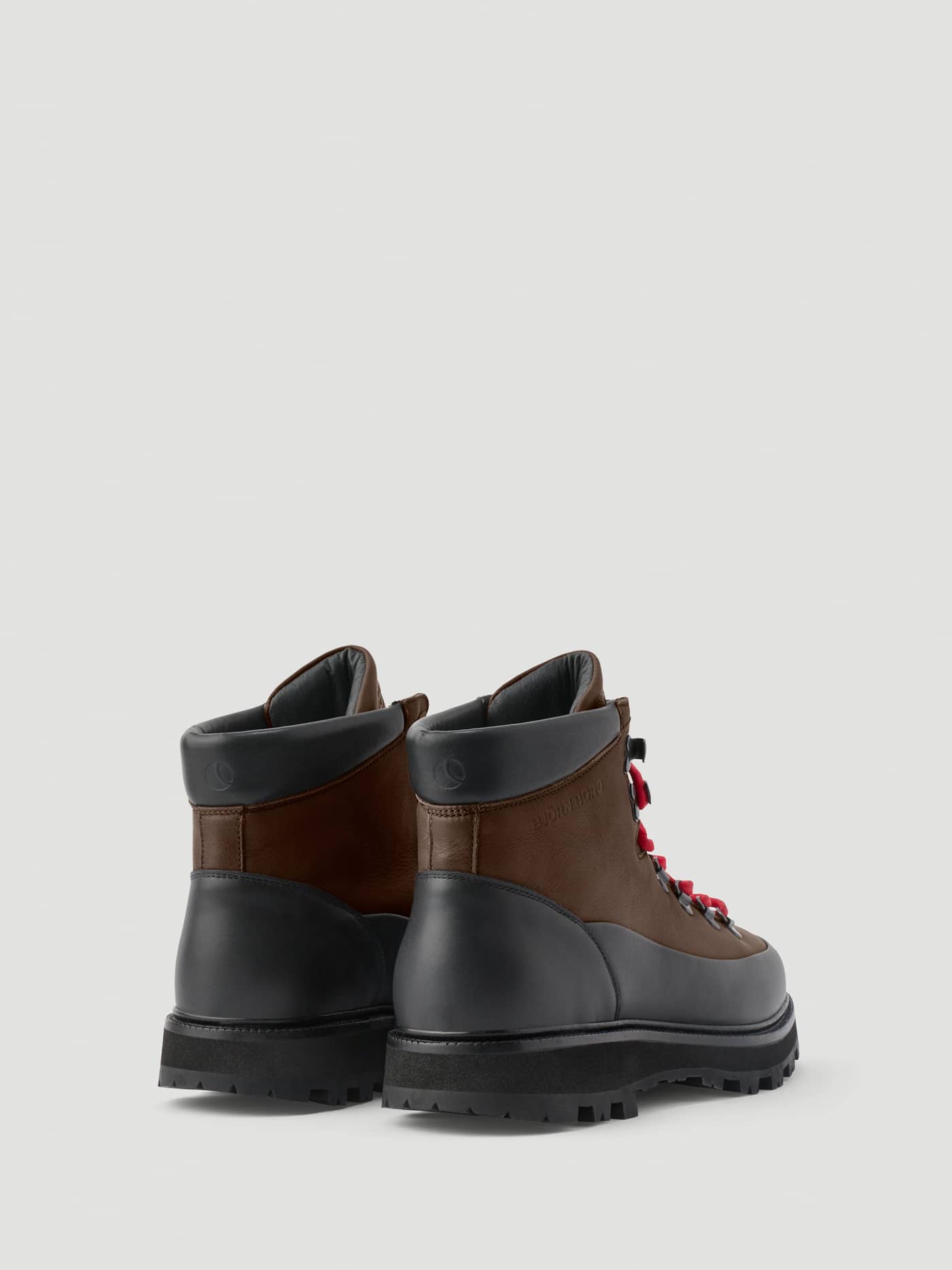 Rear view of Men's Summit Vibram Boots in black and brown leather with red laces and black embossed logo details. - Image 3