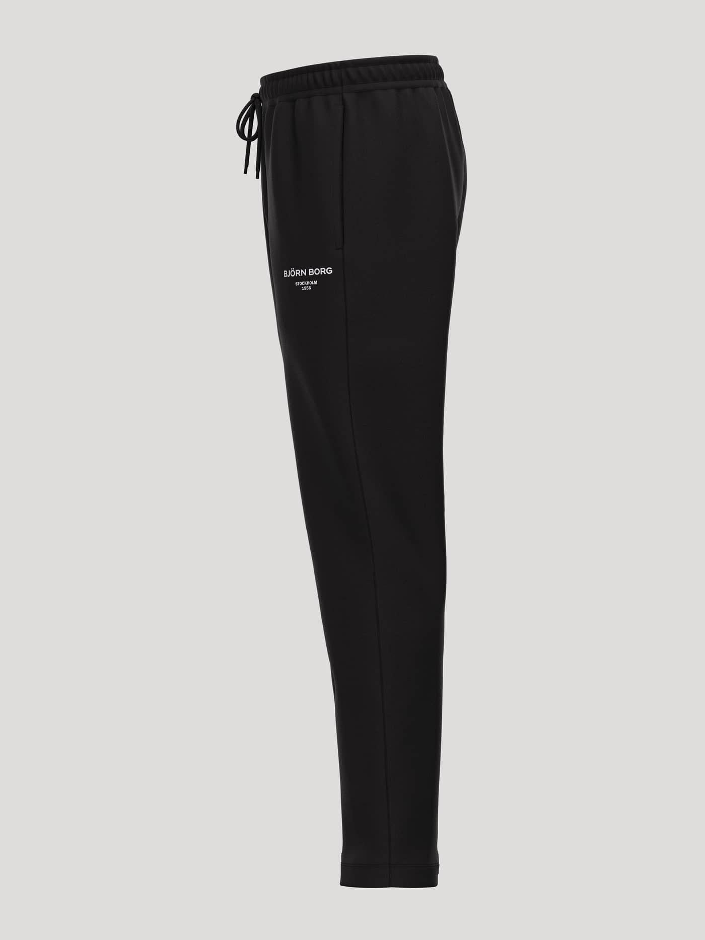 Side view of Borg Essential 1 Sweatpants in Black Beauty (Black) featuring a white logo and a tapered fit for tennis. - Image 3
