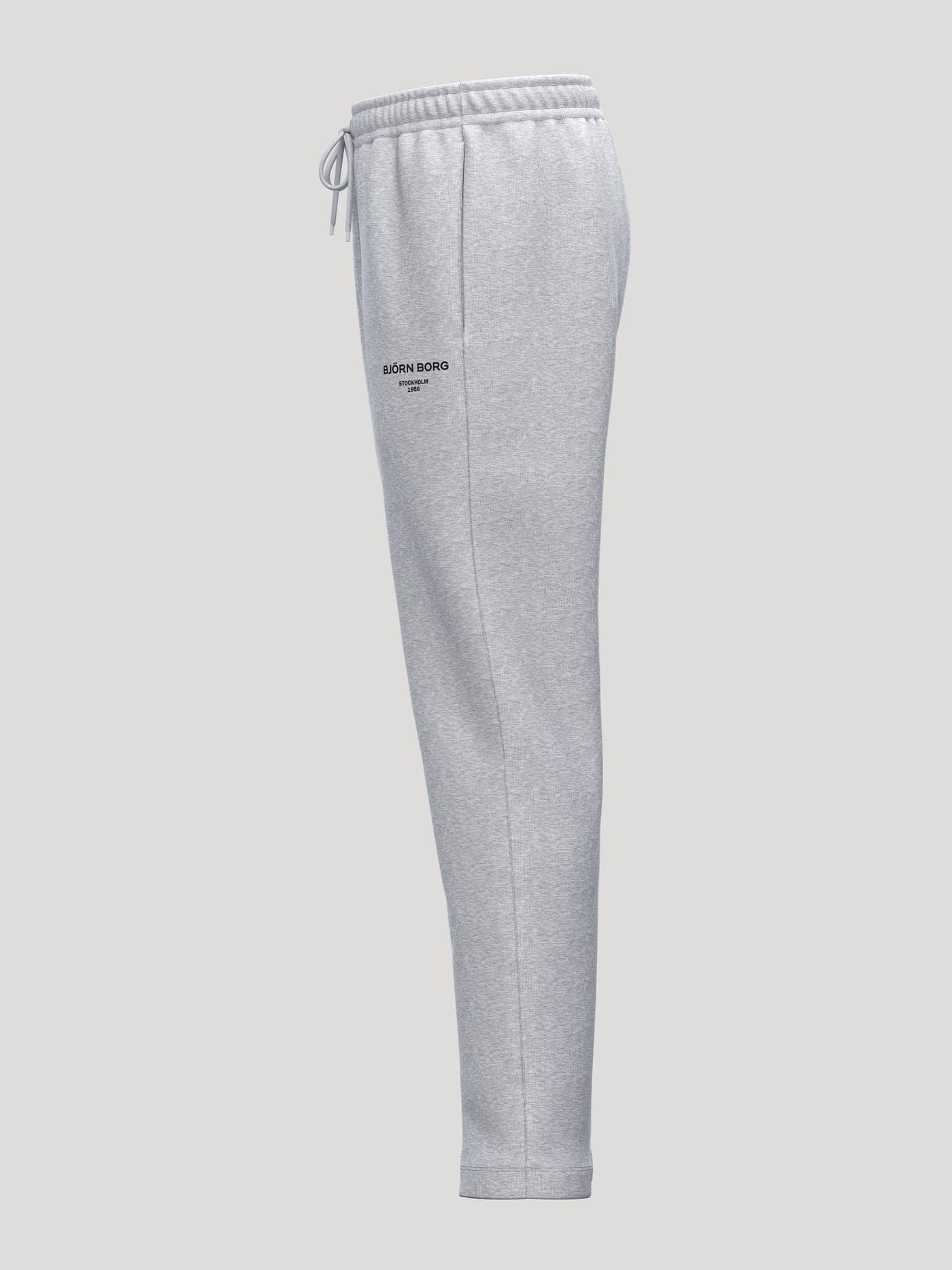 Side view of Borg Essential 1 Sweatpants in Light Grey Melange (Grey) featuring a black logo and a tapered fit. - Image 3