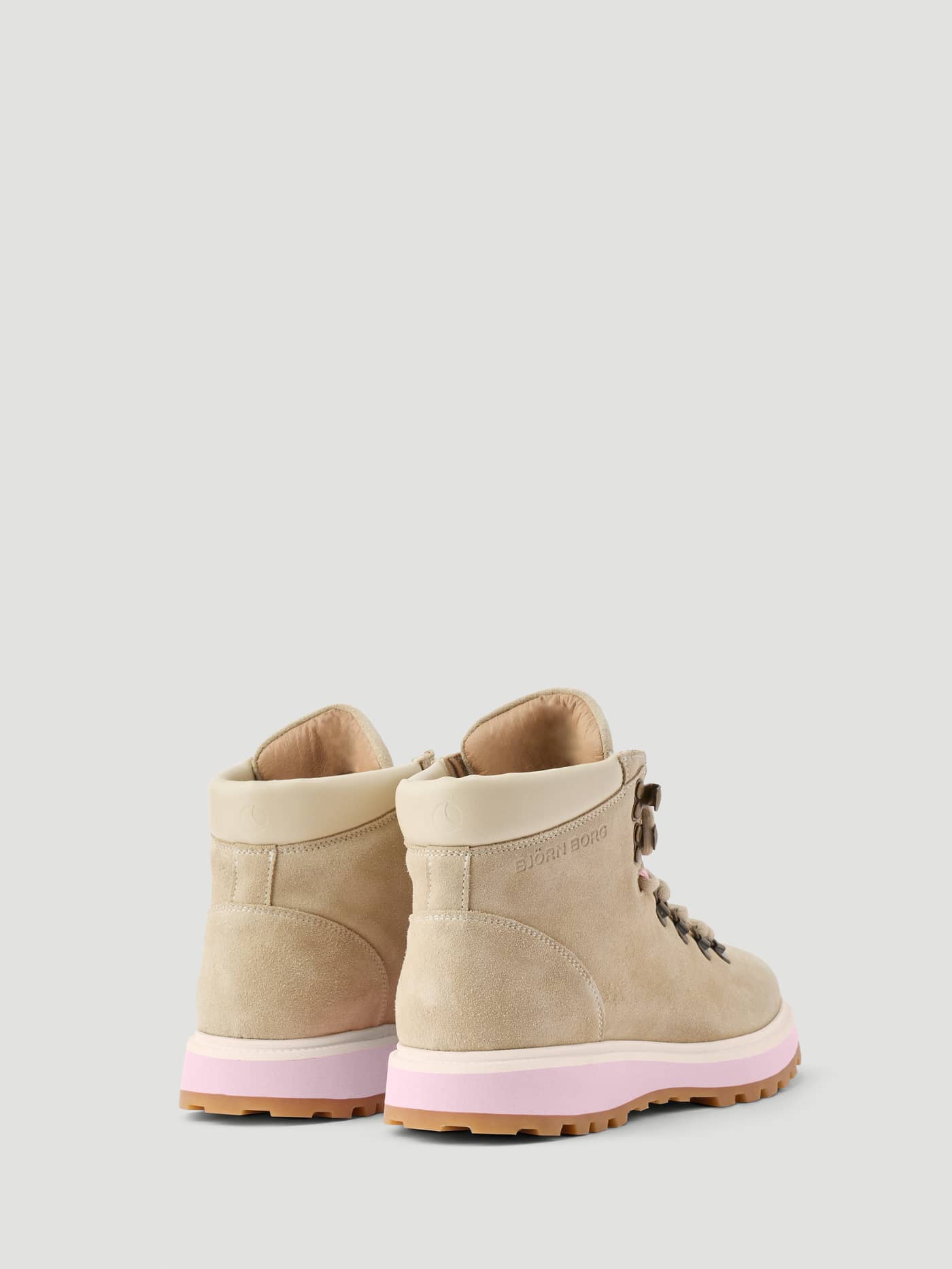 Women's Summit Boots in Beige leather, shown from the back with a pink midsole and rugged gum outsole. - Image 3