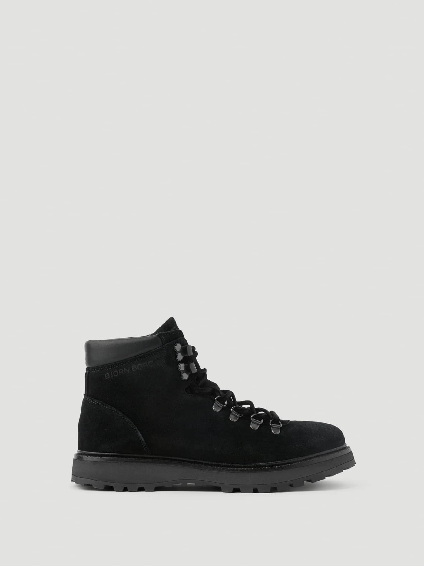 Side view of the black Women's Summit Boots in premium leather featuring a chunky treaded sole and black metal hardware. - Image 1