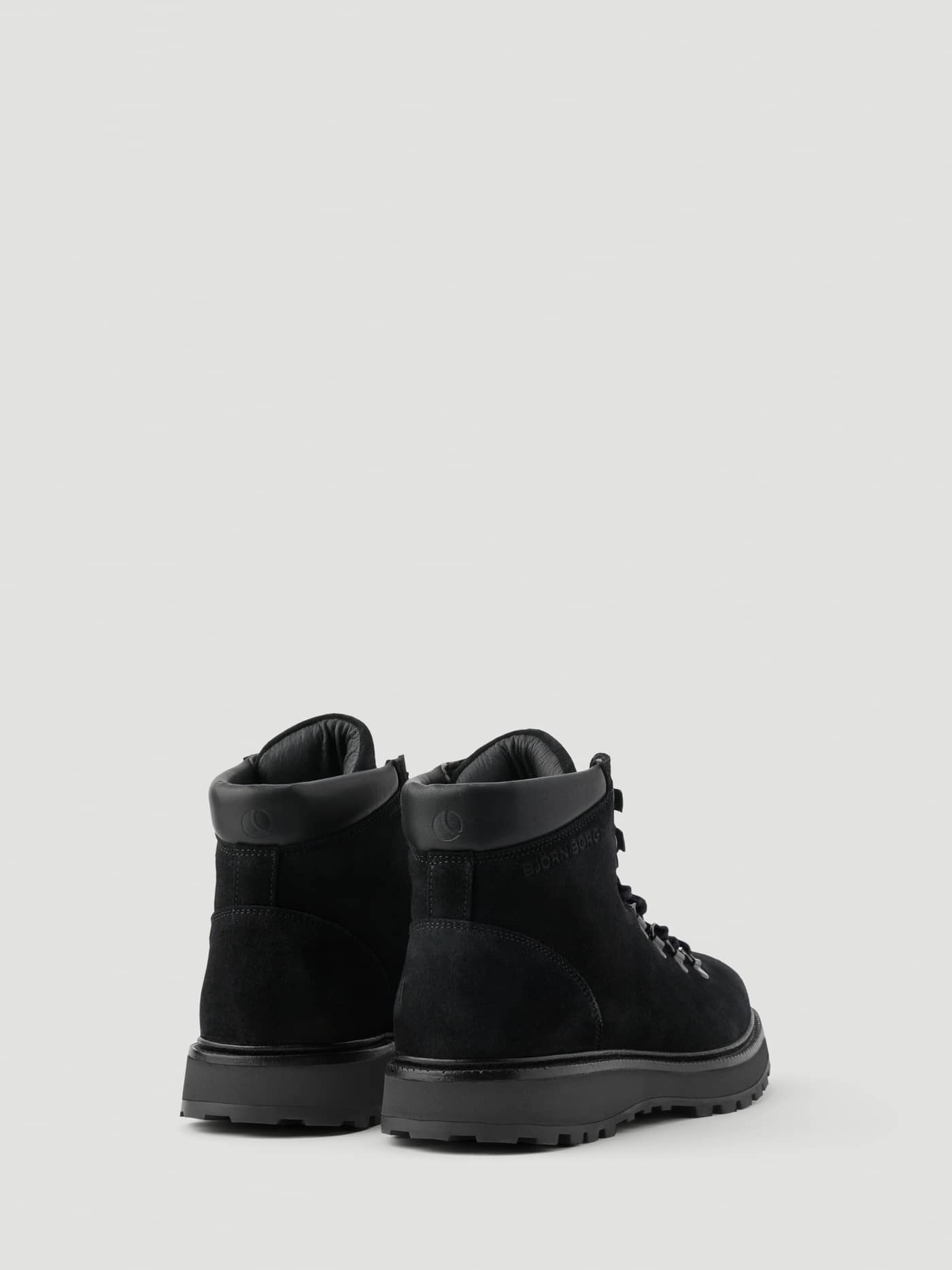 Rear view of the Women's Summit Boots in Black, featuring a premium suede finish and a durable lugged rubber sole. - Image 3