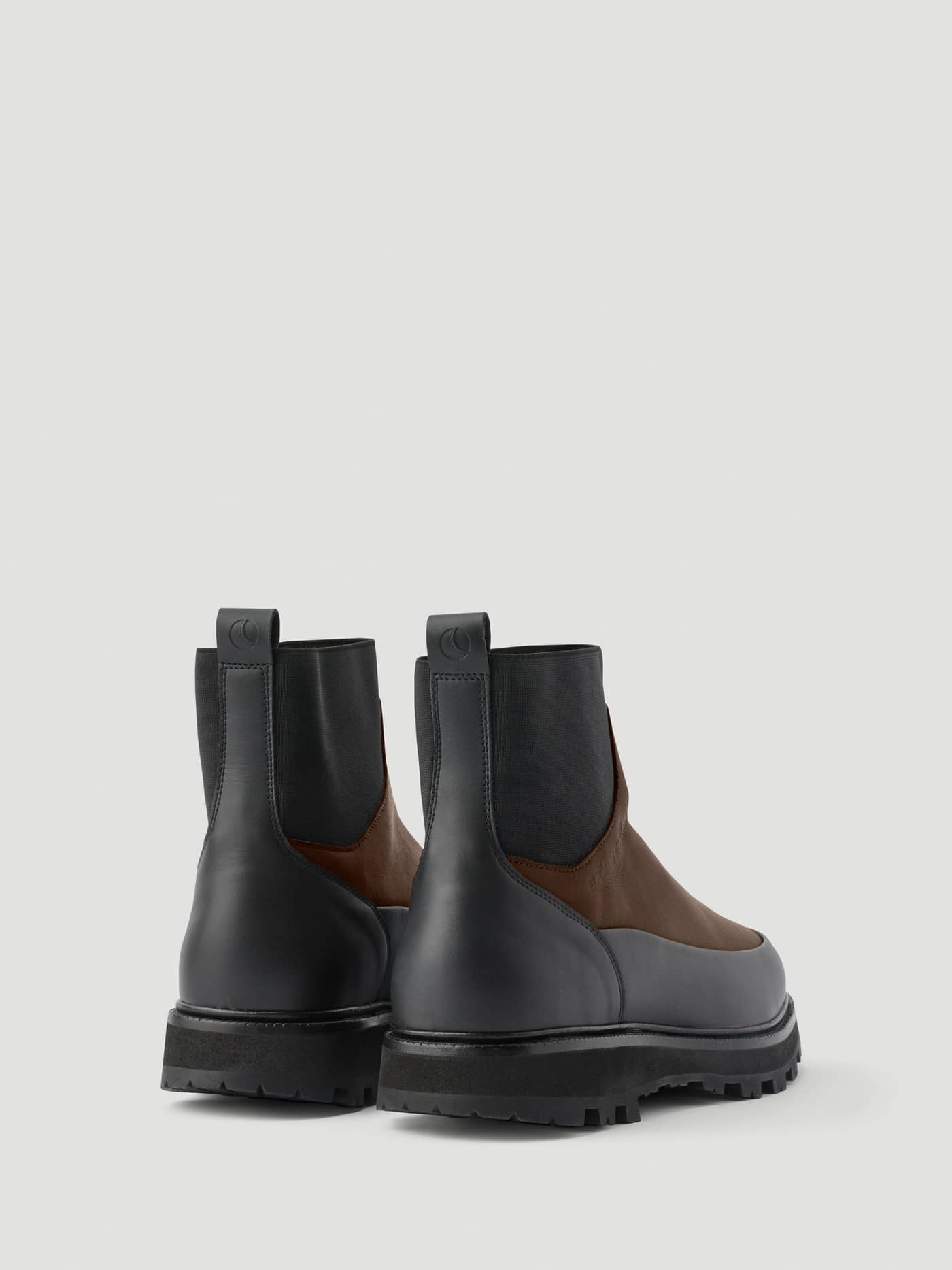Back view of Men's Summit Chelsea Vibram Boots in Brown and Black leather featuring durable lugged soles. - Image 3