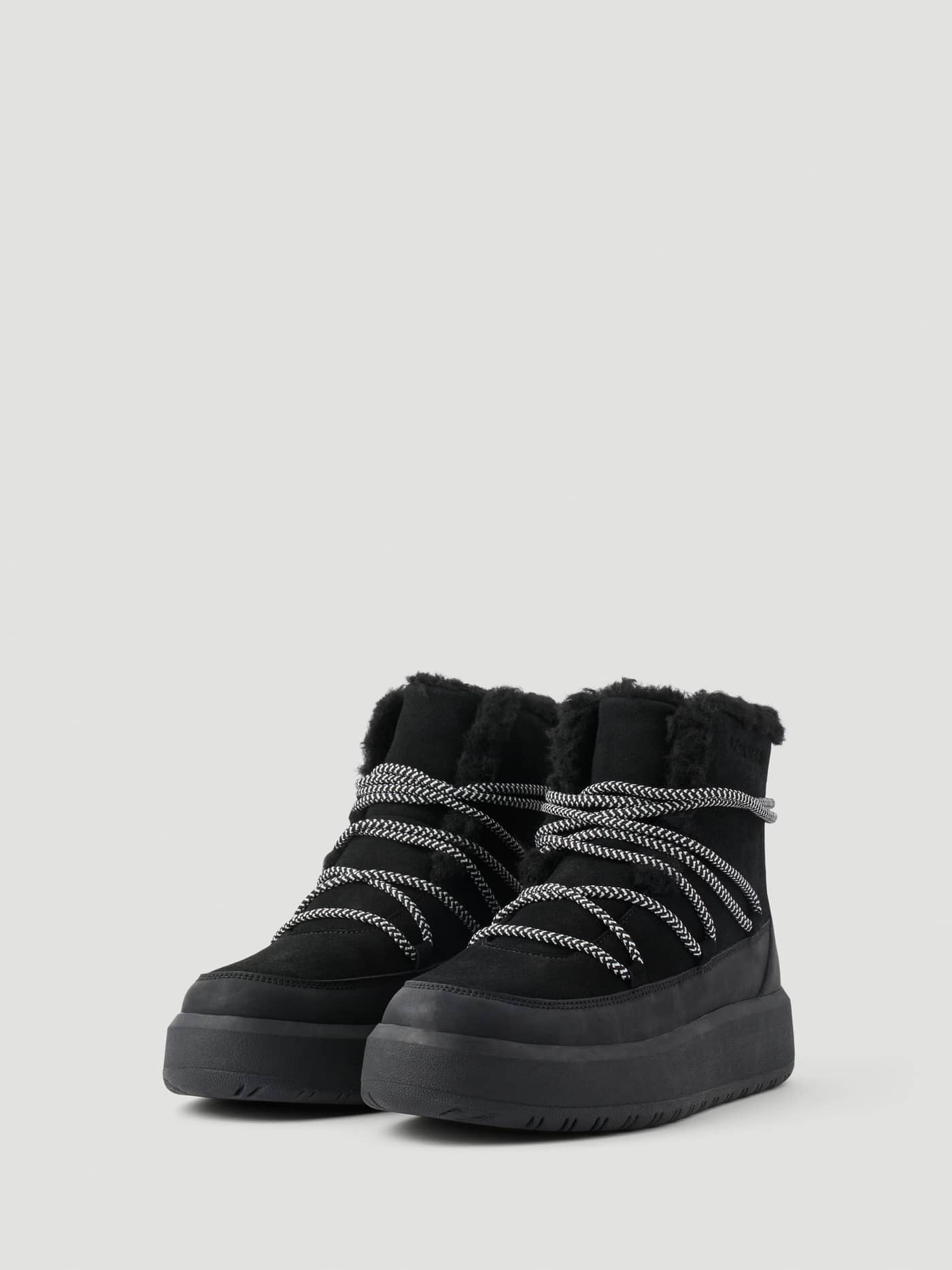 Women's Wooly Lace Up Boots in Black featuring thick platform soles, patterned laces, and a warm faux-shearling lining. - Image 2