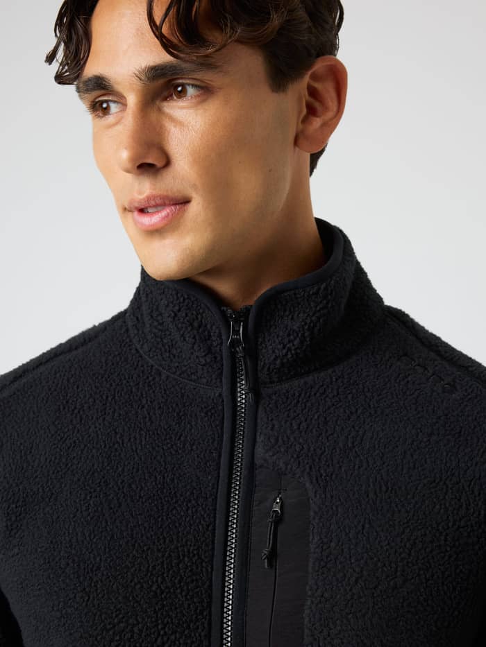 Close-up of the Borg Pile Jacket in Black Beauty (Black) featuring textured pile fleece for training and tennis. - Image 5