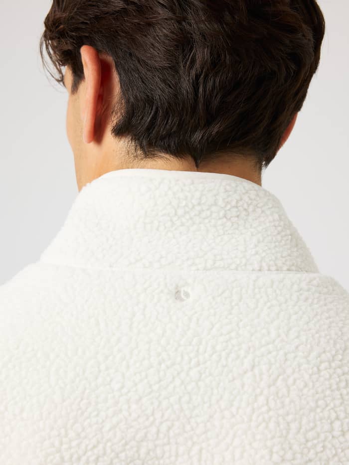 Back view of the Borg Pile Jacket in Tofu (White) for training, with a soft pile texture and tonal tennis ball embroidery. - Image 4