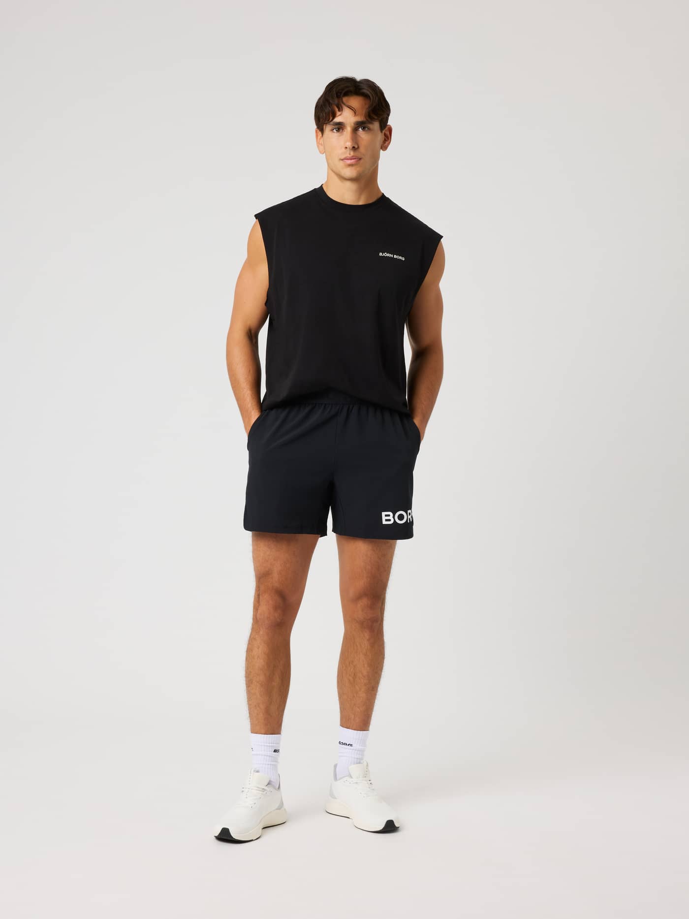 Full-body front view of the Borg Gym Sleeveless T-Shirt in Black Beauty (Black) with a white chest logo for training. - Image 3
