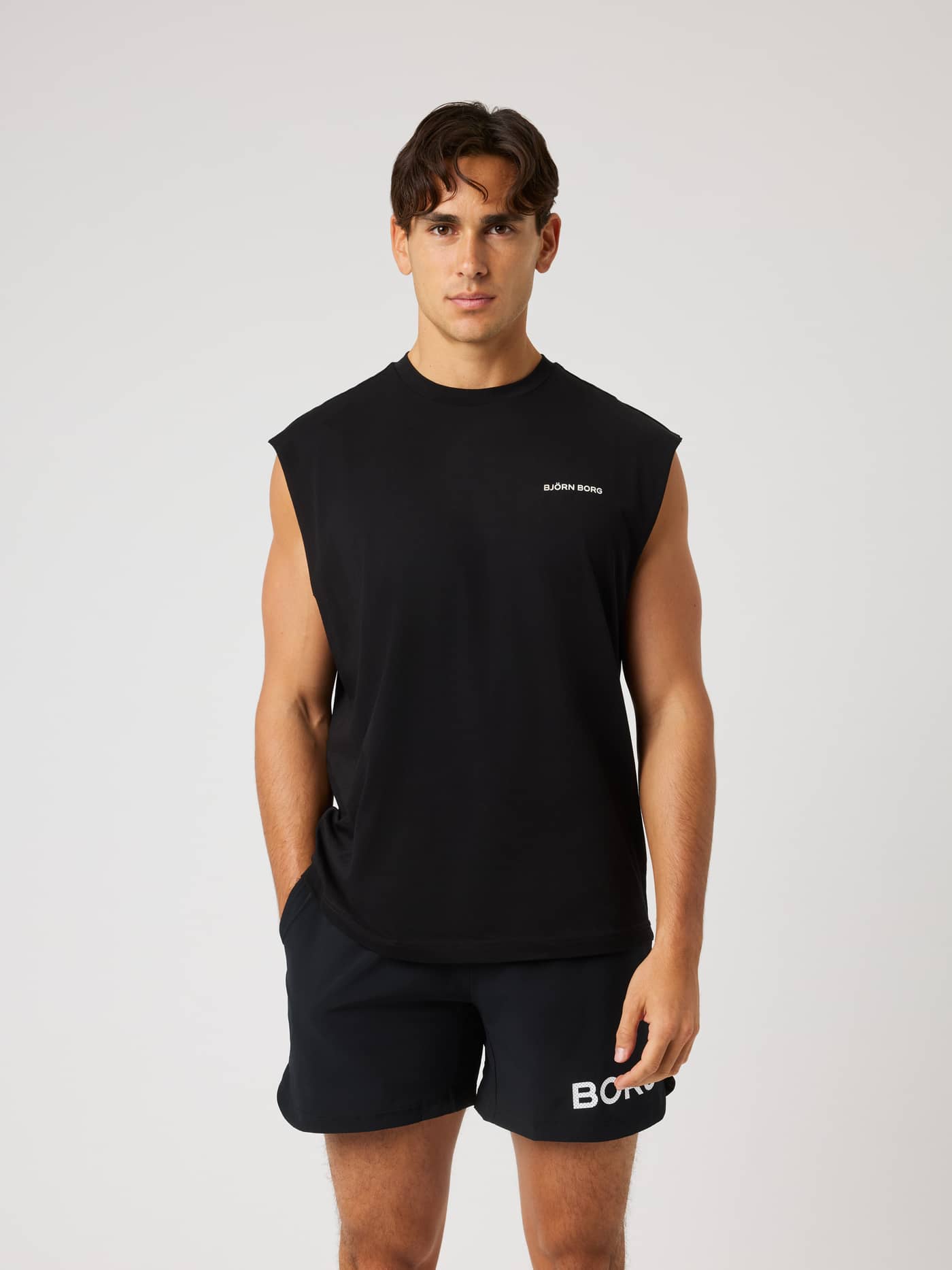 Vue de face d'un homme portant le Borg Gym Sleeveless T-Shirt en Black Beauty (Noir) pour l'entraînement avec logo blanc. - Image 1