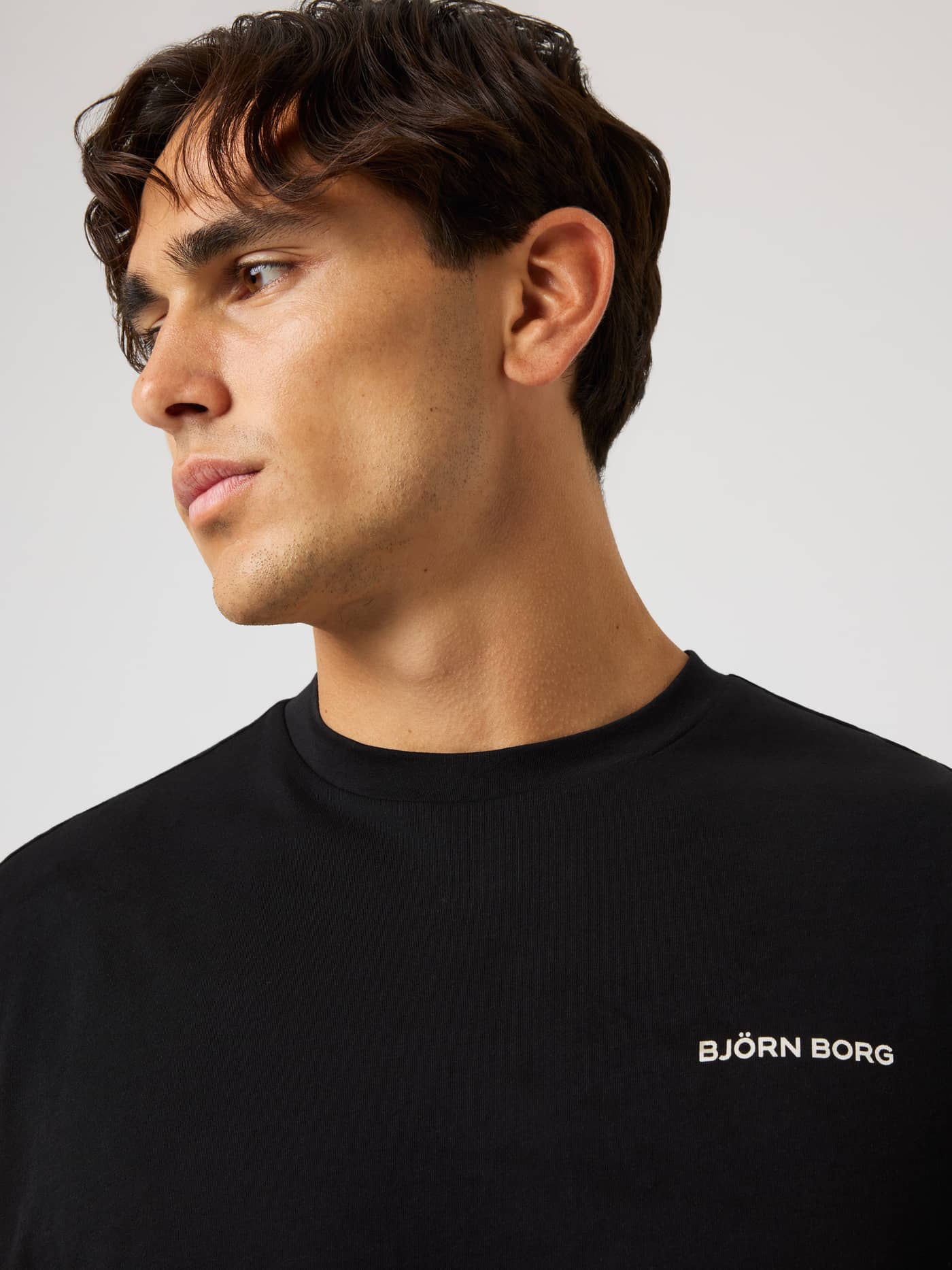 Close-up of the Borg Gym Sleeveless T-Shirt in Black Beauty (Black) with a white logo for gym training and tennis. - Image 4