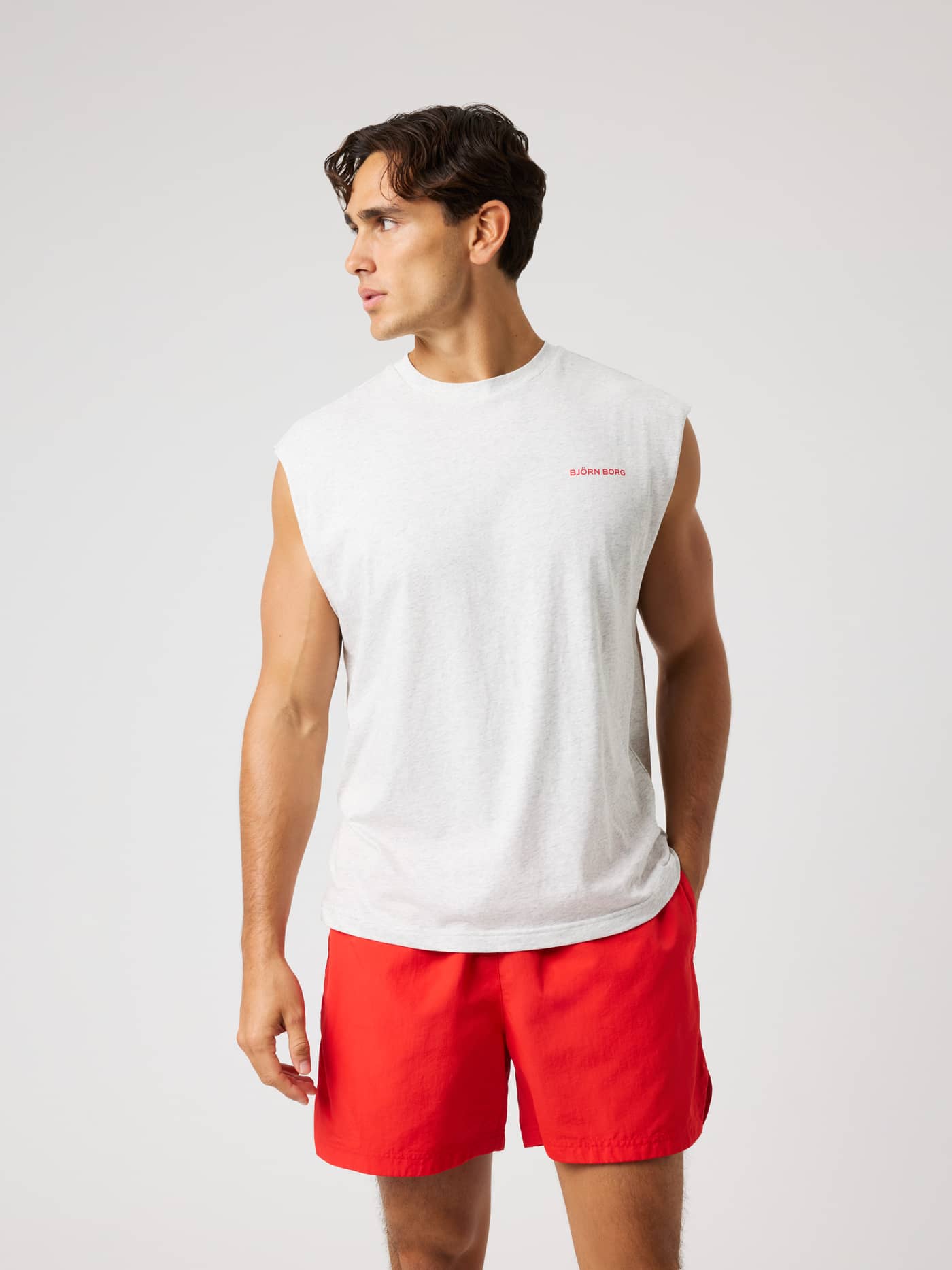 Front view of the Borg Gym Sleeveless T-Shirt in Ultra Light Grey Melange (Grey) with a red chest logo for training. - Image 2