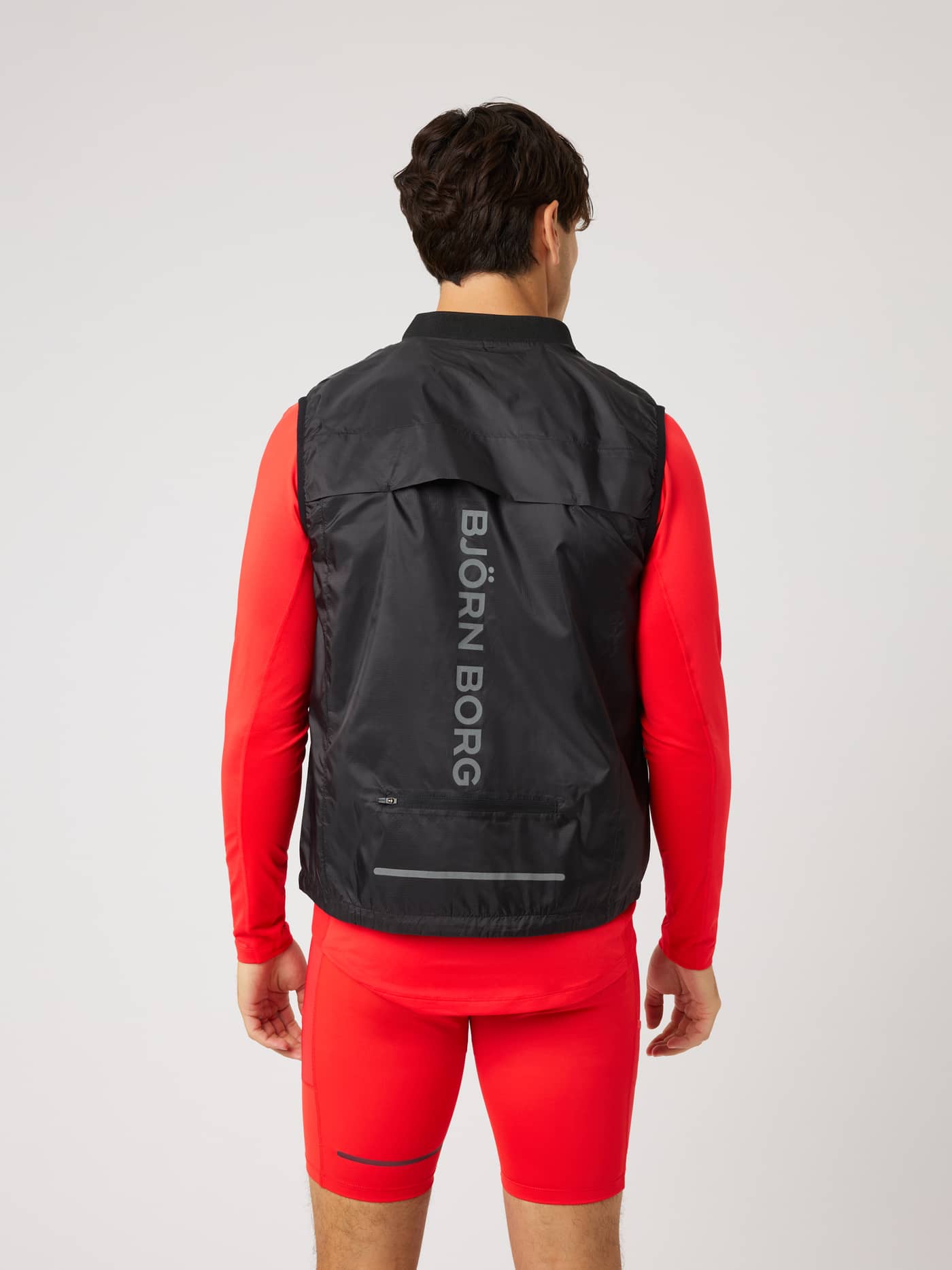 Back view of the Borg Performance Vest in Black Beauty (Black) featuring a silver vertical logo for running. - Image 2