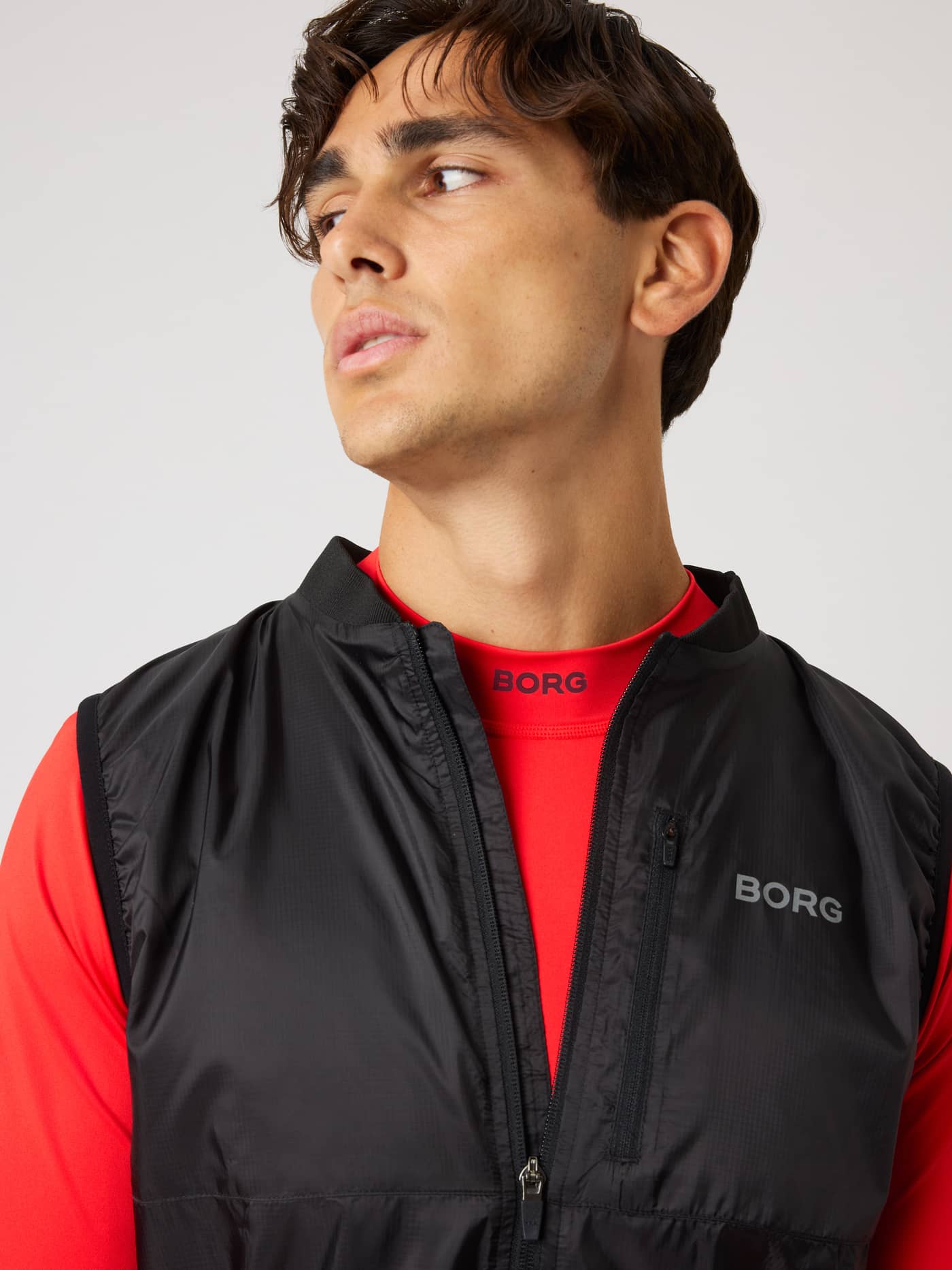 Close-up of the Borg Performance Vest in Black Beauty (Black) with a grey logo, designed for performance running. - Image 5