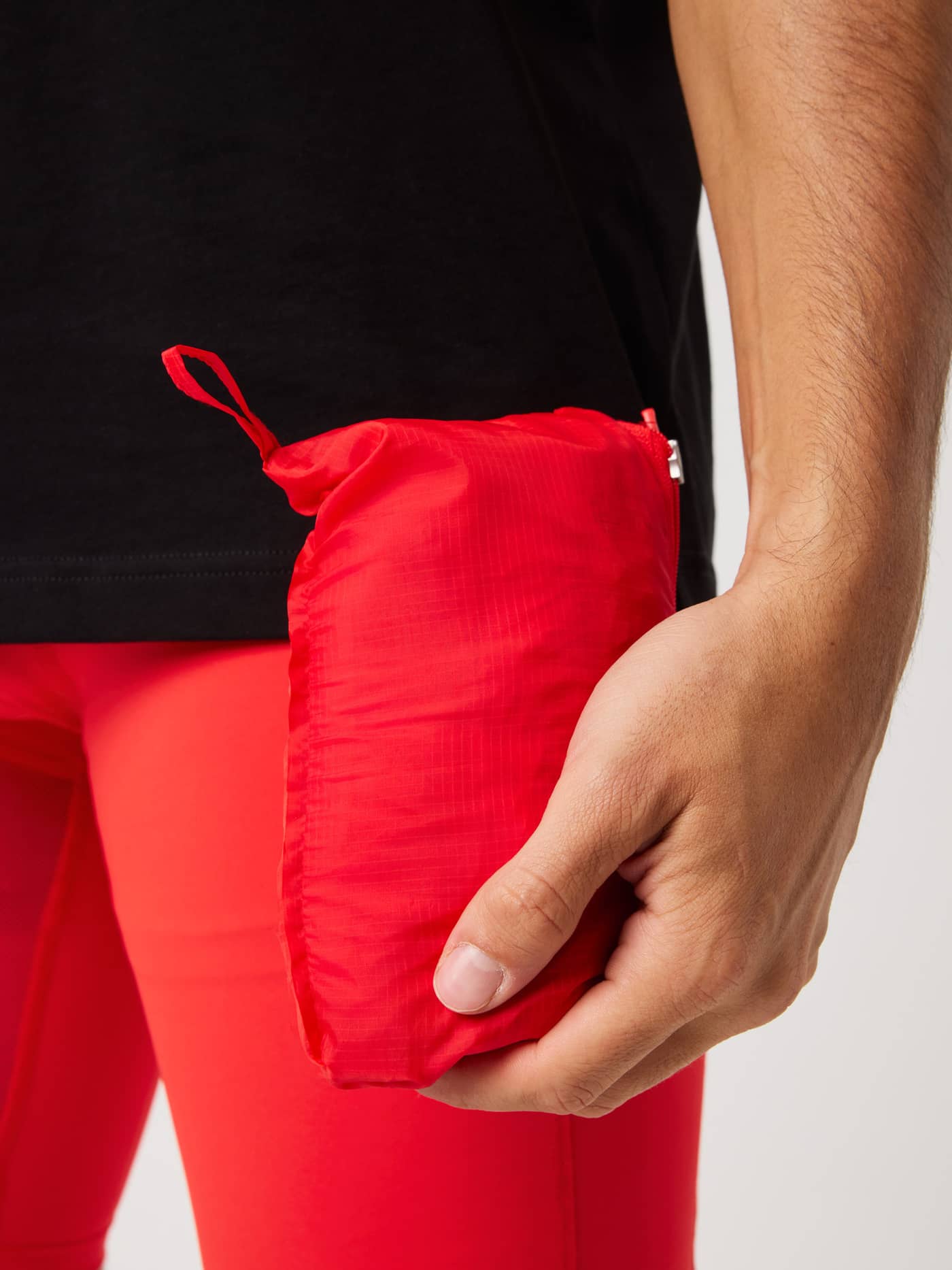 Borg Performance Wind Jacket in Flame Scarlet (Red) packed for easy storage during running and training. - Image 5