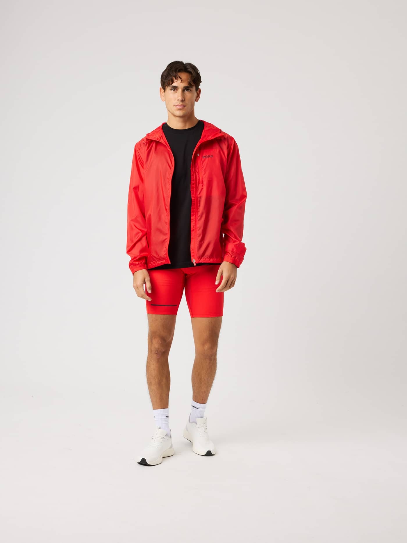 Full-body front view of a model wearing the water-repellent Borg Performance Wind Jacket in Flame Scarlet (Red) for running. - Image 3