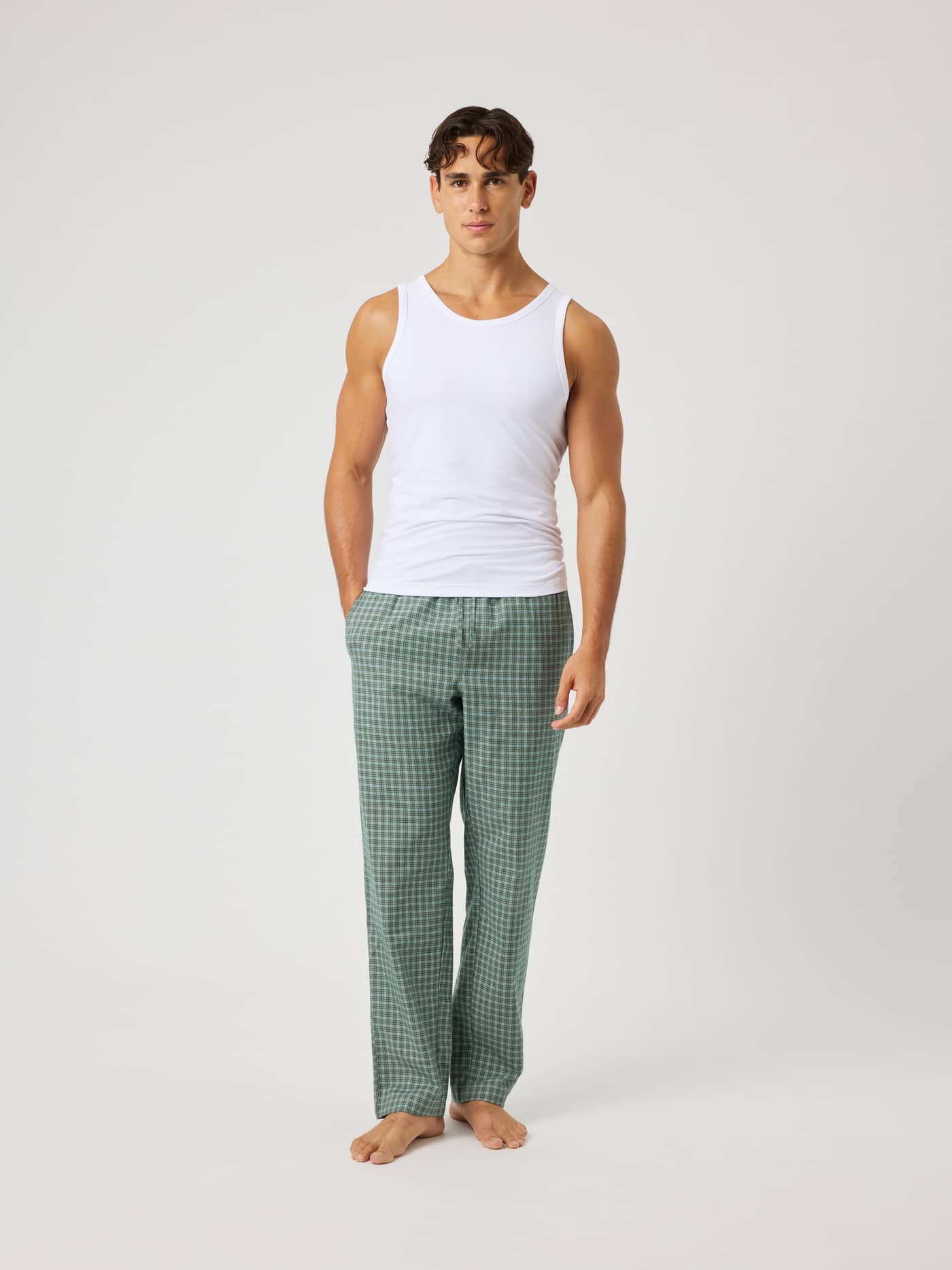 Full-body front view of a man wearing Björn Borg Core Flannel Pyjama Pants in a green and white check pattern. - Image 3