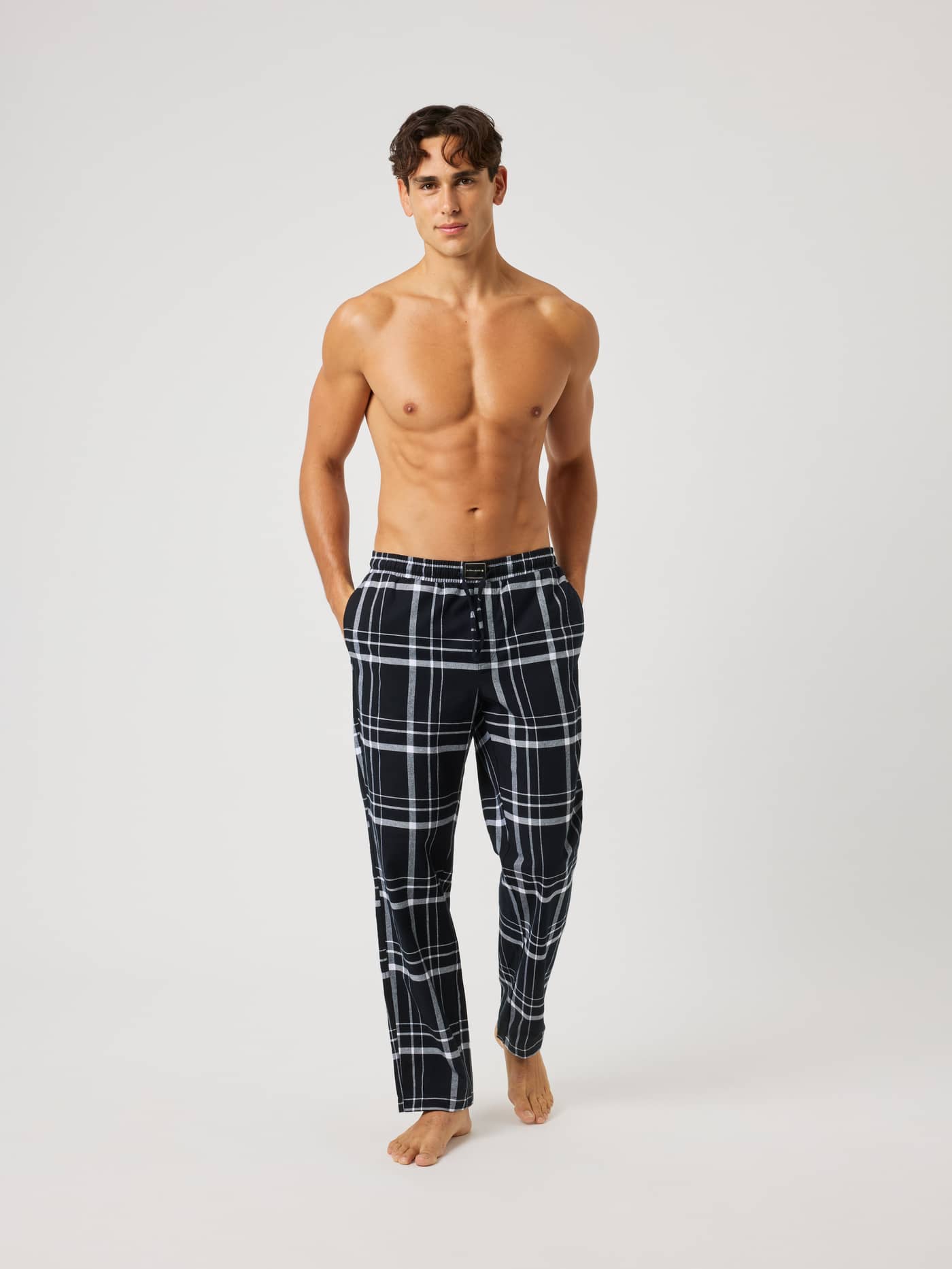 Front view of a man wearing Core Flannel Pyjama Pants in a black and white plaid Lounge Pattern (Black). - Image 4