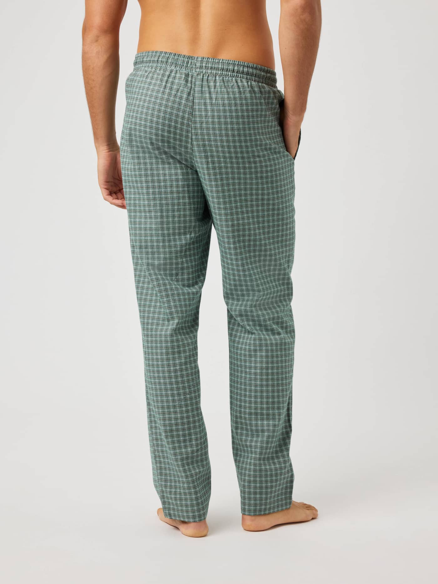 Back view of a model wearing Core Flannel Pyjama Pants in a green and black checked brushed flannel. - Image 2