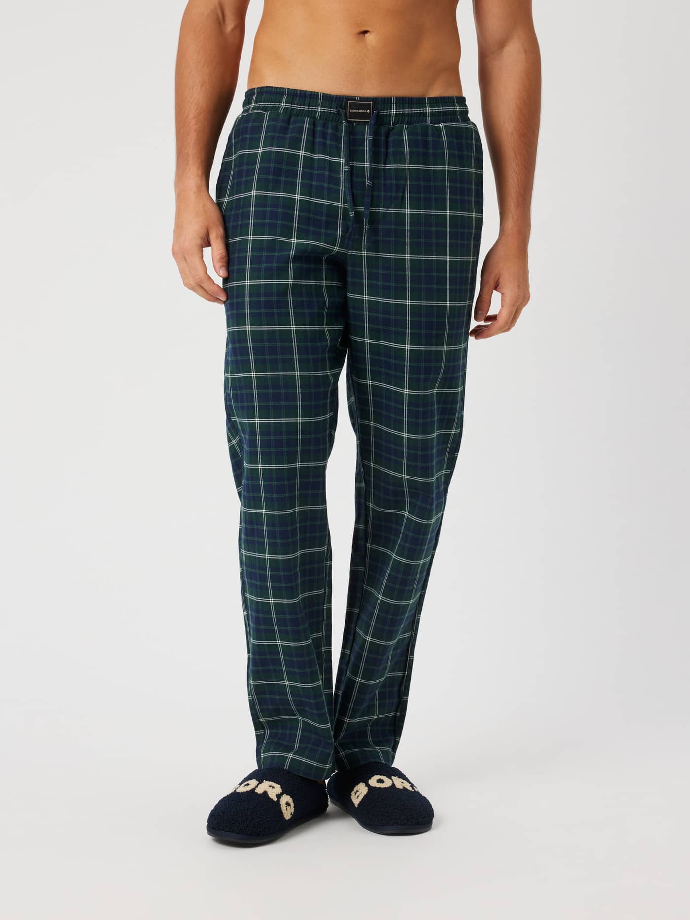 Front view of the Core Flannel Pyjama Pants in a tartan plaid pattern featuring an elastic waistband and drawstring. - Image 1