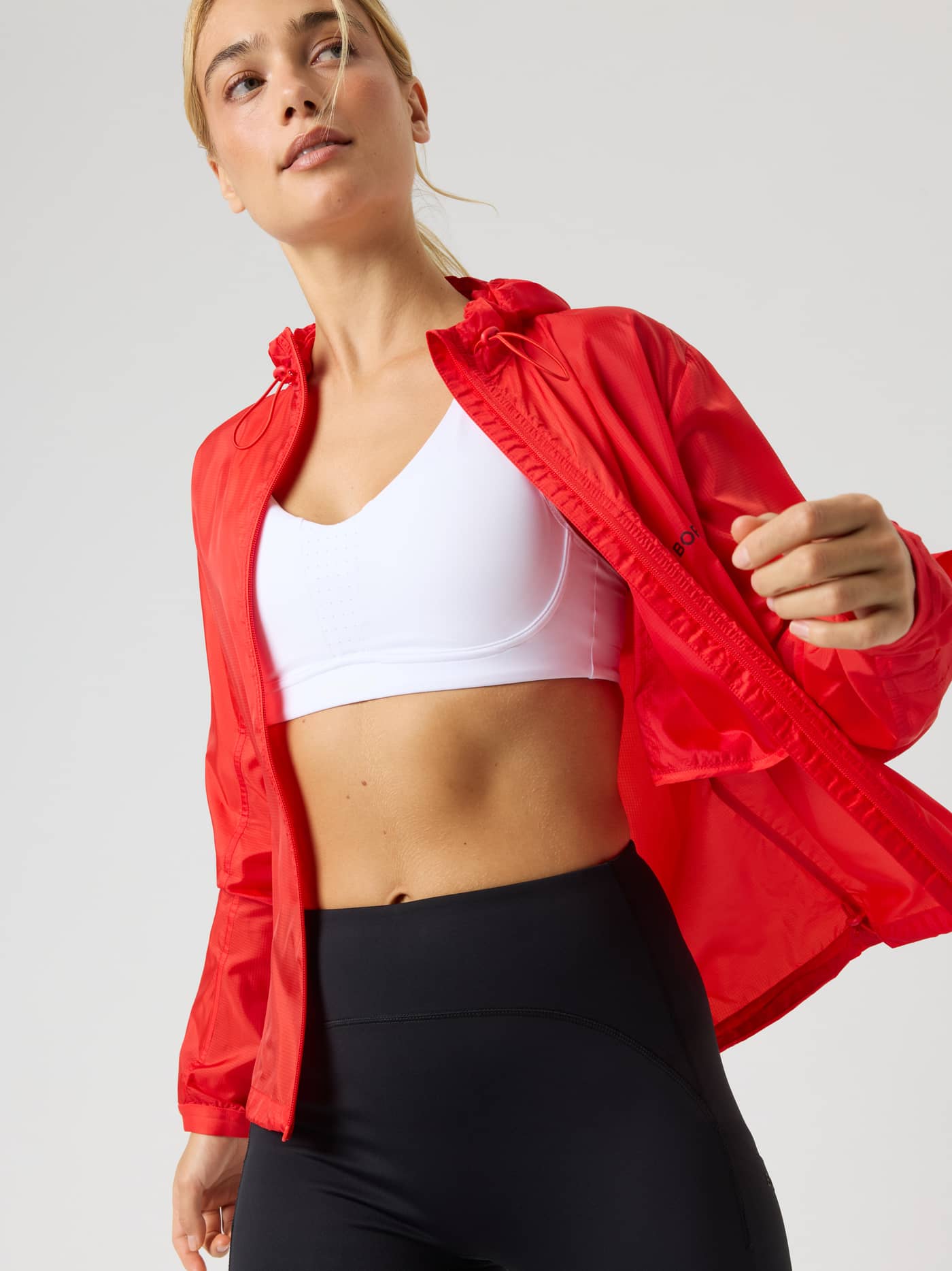 Borg Performance Wind Jacket in Flame Scarlet (Red), a functional windproof running jacket with a hood. - Image 5