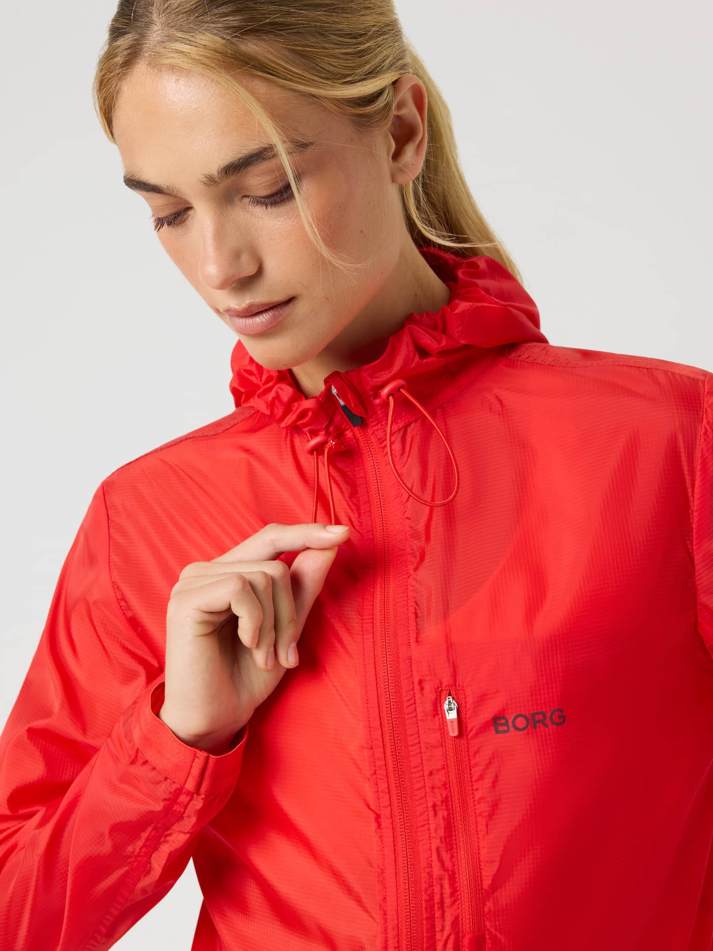 Borg Performance Wind Jacket in Flame Scarlet (Red) for running, featuring a black logo and technical ripstop pattern. - Image 4