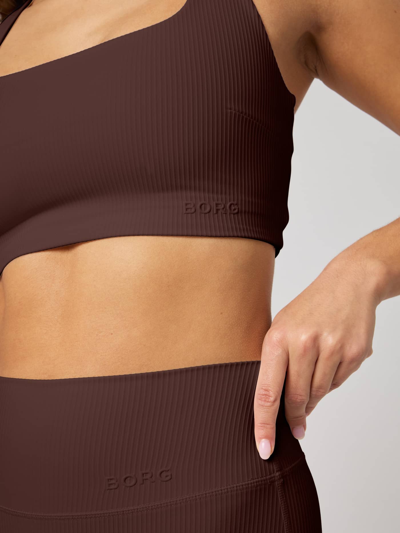 Studio Ribbed Racerback Bra in Coffee Bean (Brown) with a ribbed finish and tone-on-tone logo, designed for training. - Image 5