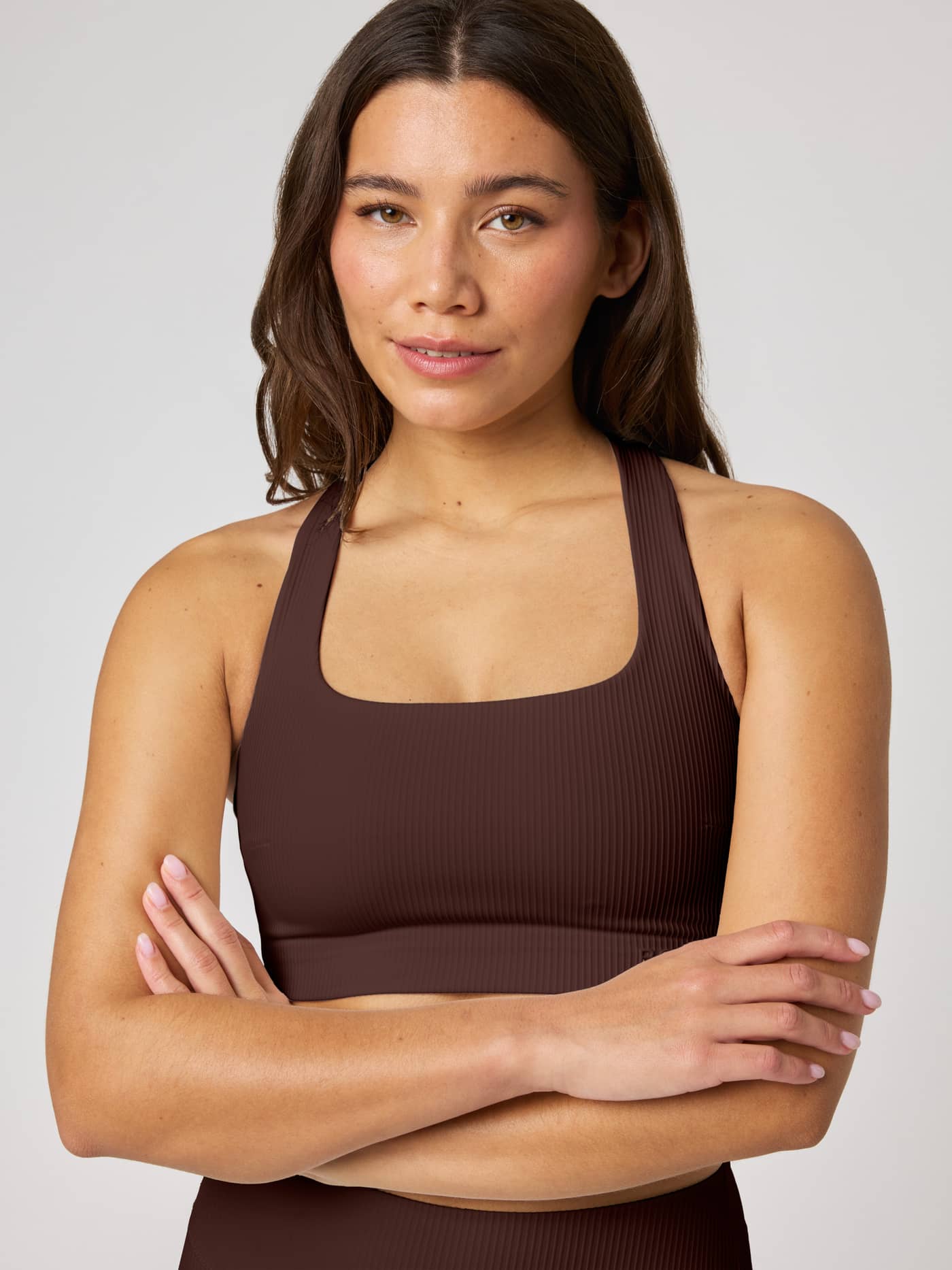 Front view of the Studio Ribbed Racerback Bra in Coffee Bean (Brown) featuring a premium ribbed texture for training. - Image 4