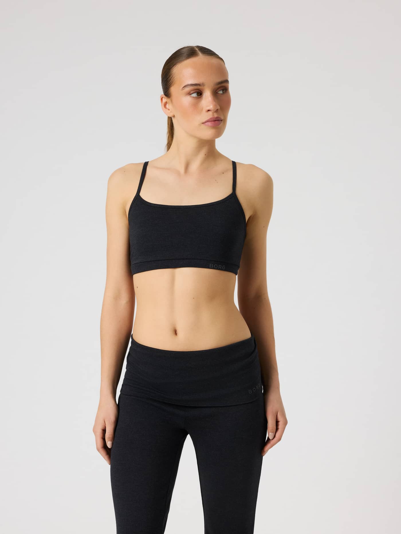 Front view of the Björn Borg Studio Flow Racerback Bra in Black with a tonal logo for a premium training look. - Image 4