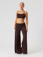 Front view of a model wearing the Studio Flow Folded Wide Pants in Coffee Bean (Brown) with a foldable high waist.