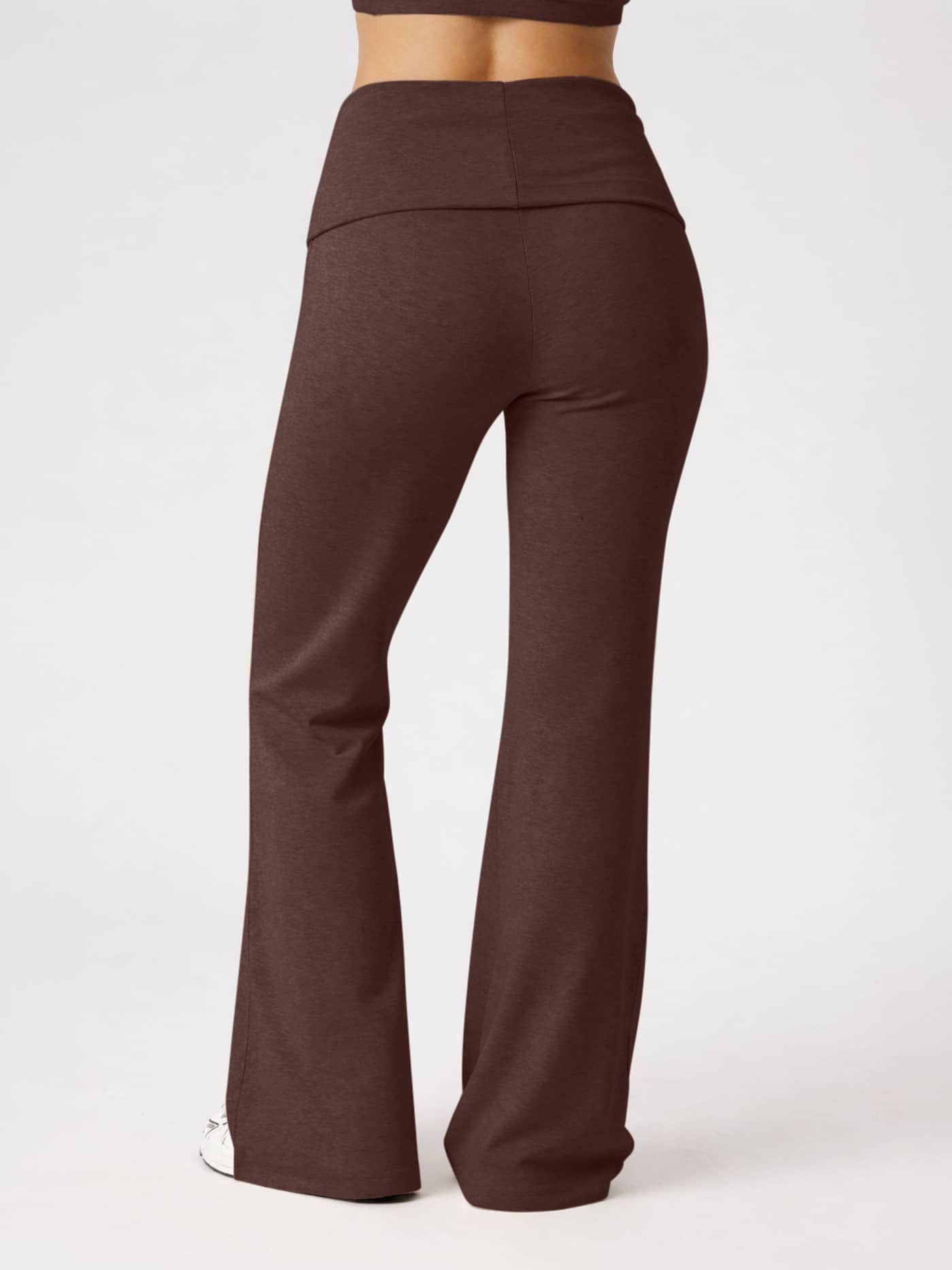 Back view of a woman wearing the Studio Flow Folded Wide Pants in Coffee Bean (Brown) with a foldable waistband for training. - Image 3