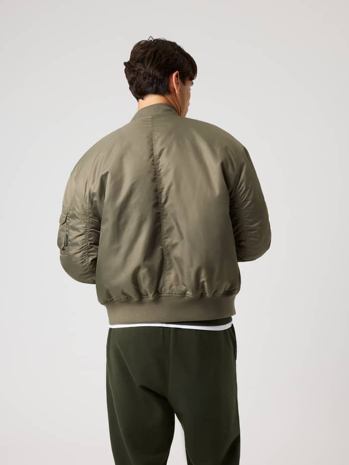 Back view of a man wearing the padded Borg Bomber Jacket in Kalamata (Green) for training, tennis, and daily commutes. - Image 2