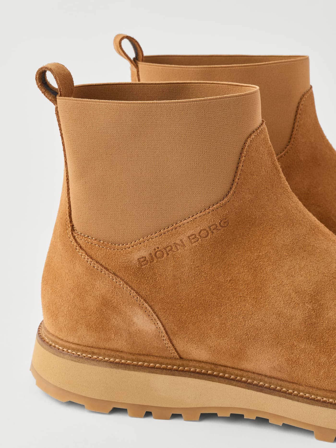 Side profile of the Men's Summit Chelsea Boots in Brown suede, featuring a debossed logo and elasticated side panels. - Image 4