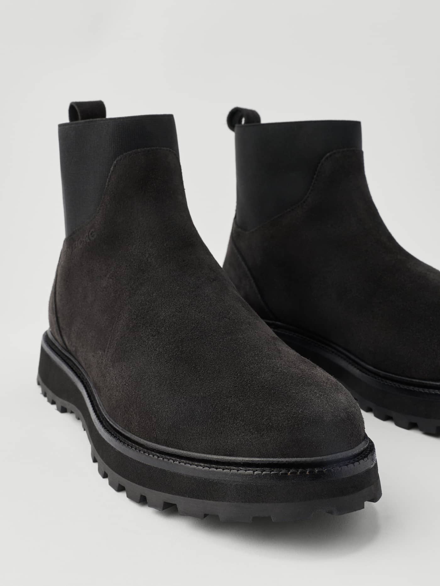 Women's Summit Chelsea Boots in Black, featuring a premium suede finish, chunky lug soles, and elastic side panels. - Image 5