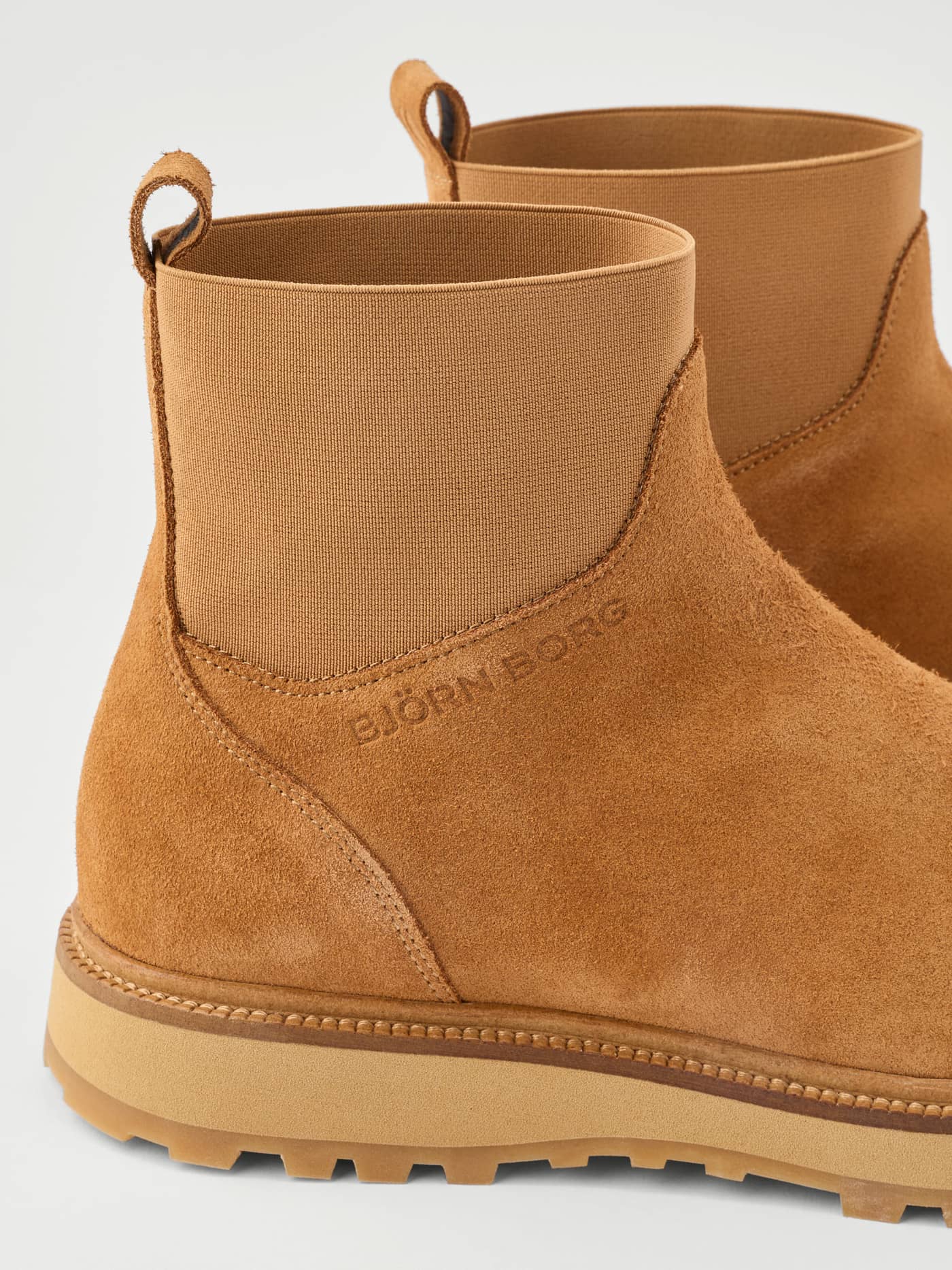 Women's Summit Chelsea Boots in Brown featuring a close-up side view with a tonal embossed logo and soft suede finish. - Image 4