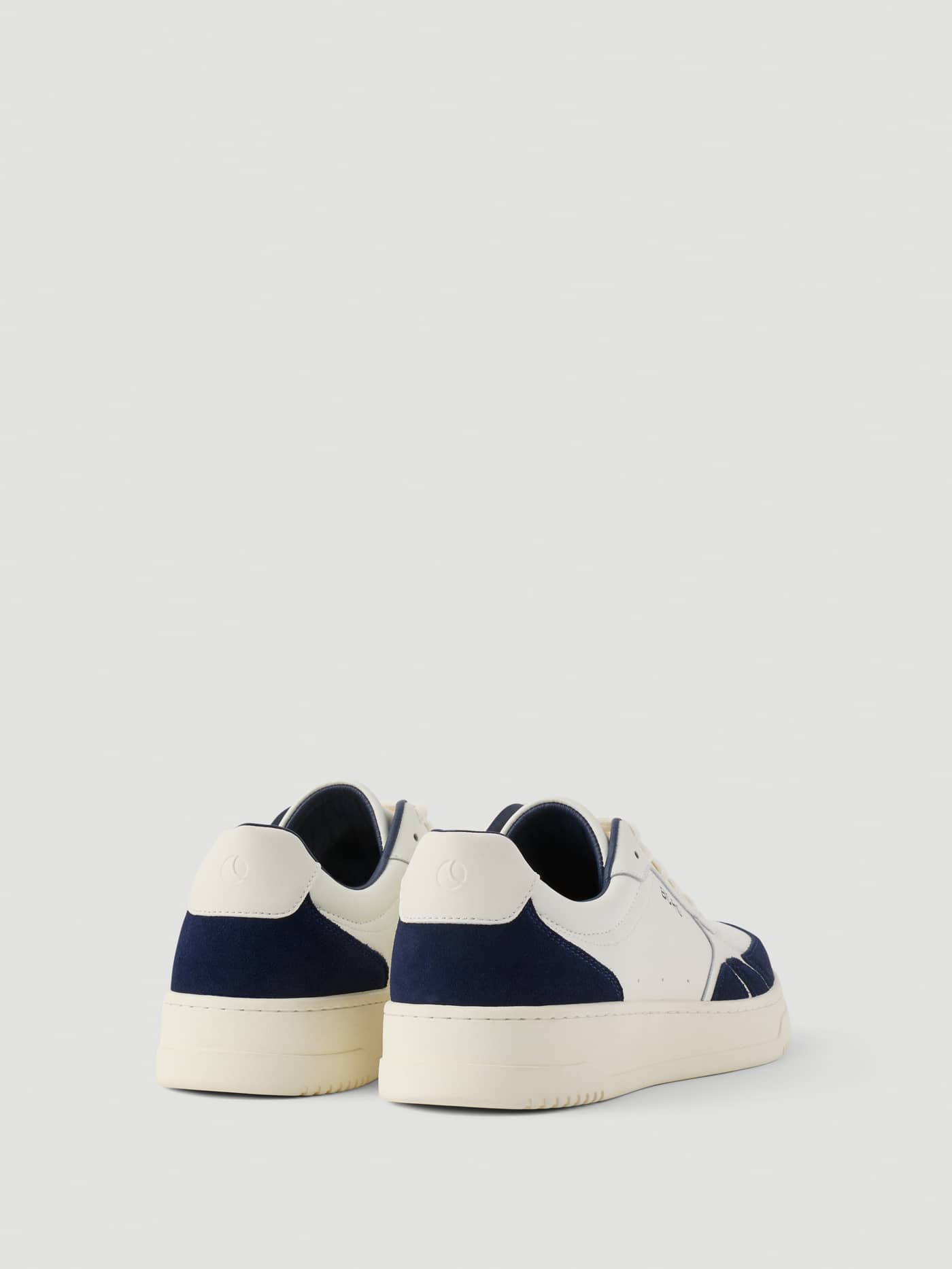 Back view of Men's Victory Leather Sneakers in white and navy, featuring a premium leather finish and tennis style. - Image 4