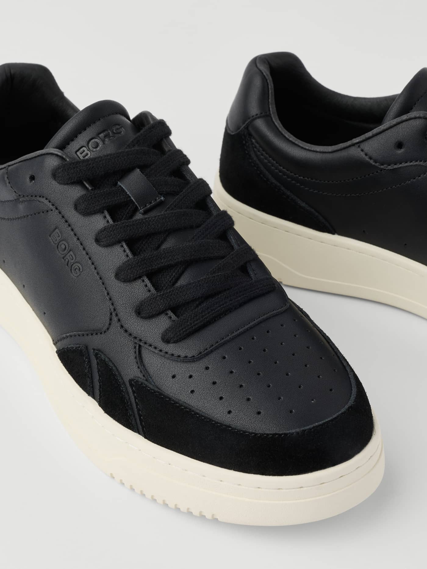 Close-up of black Men's Victory Leather Sneakers with a tennis-inspired design, suede panels, and a black logo. - Image 4