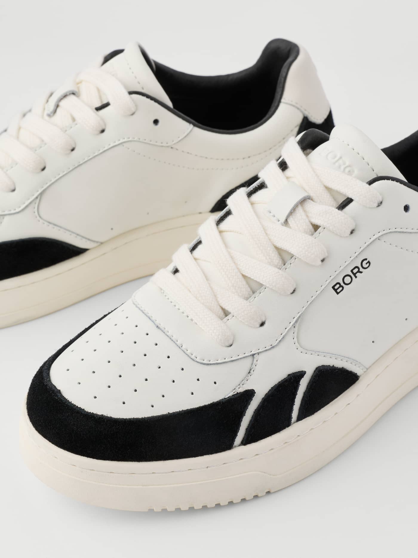 Close-up of the Women's Victory Leather Sneakers in white and black leather with a black logo for a premium tennis look. - Image 4