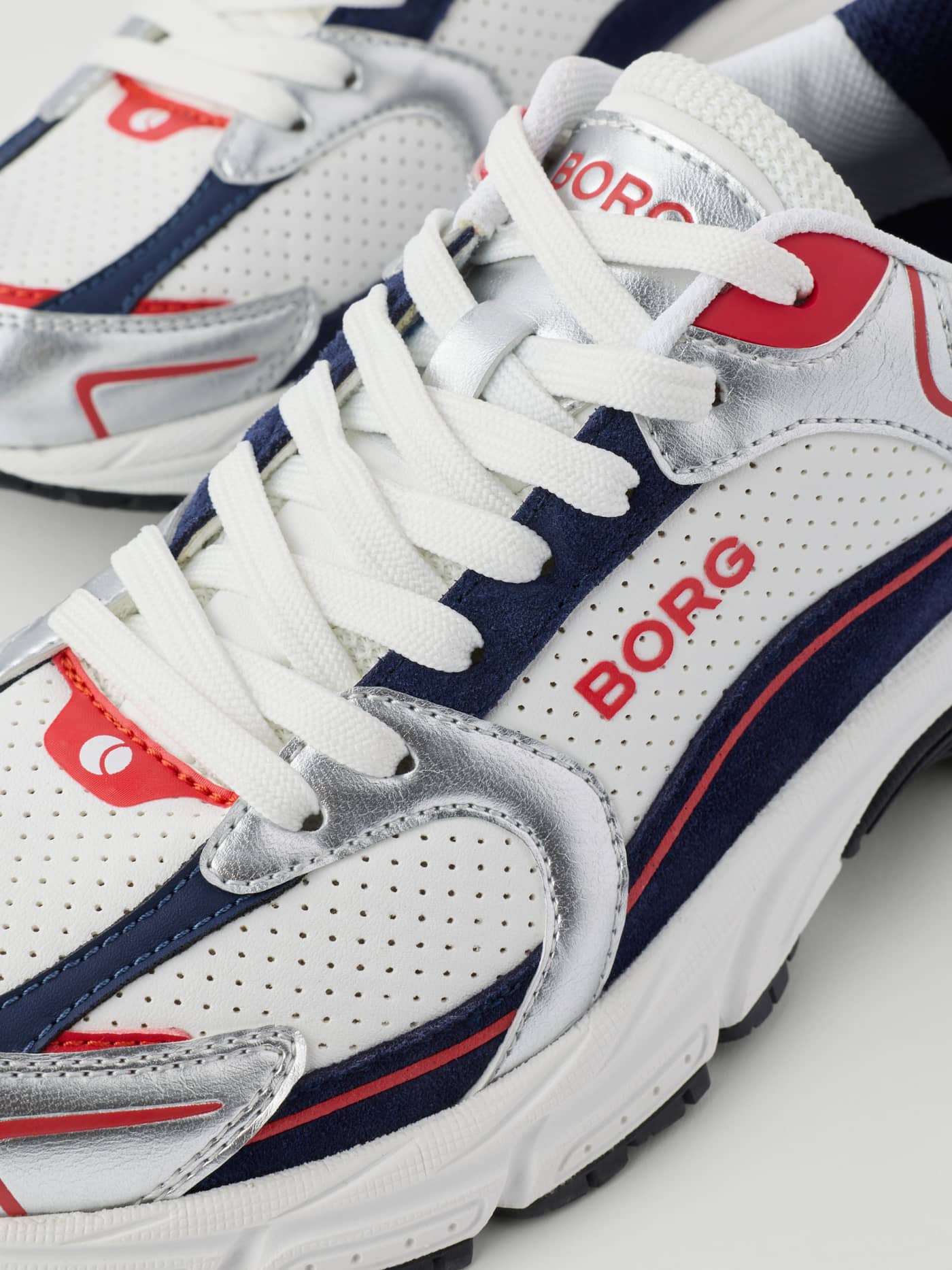 Close-up of Women's Alley Sneakers in White and Navy synthetic leather with a red BORG logo and running-inspired design. - Image 5