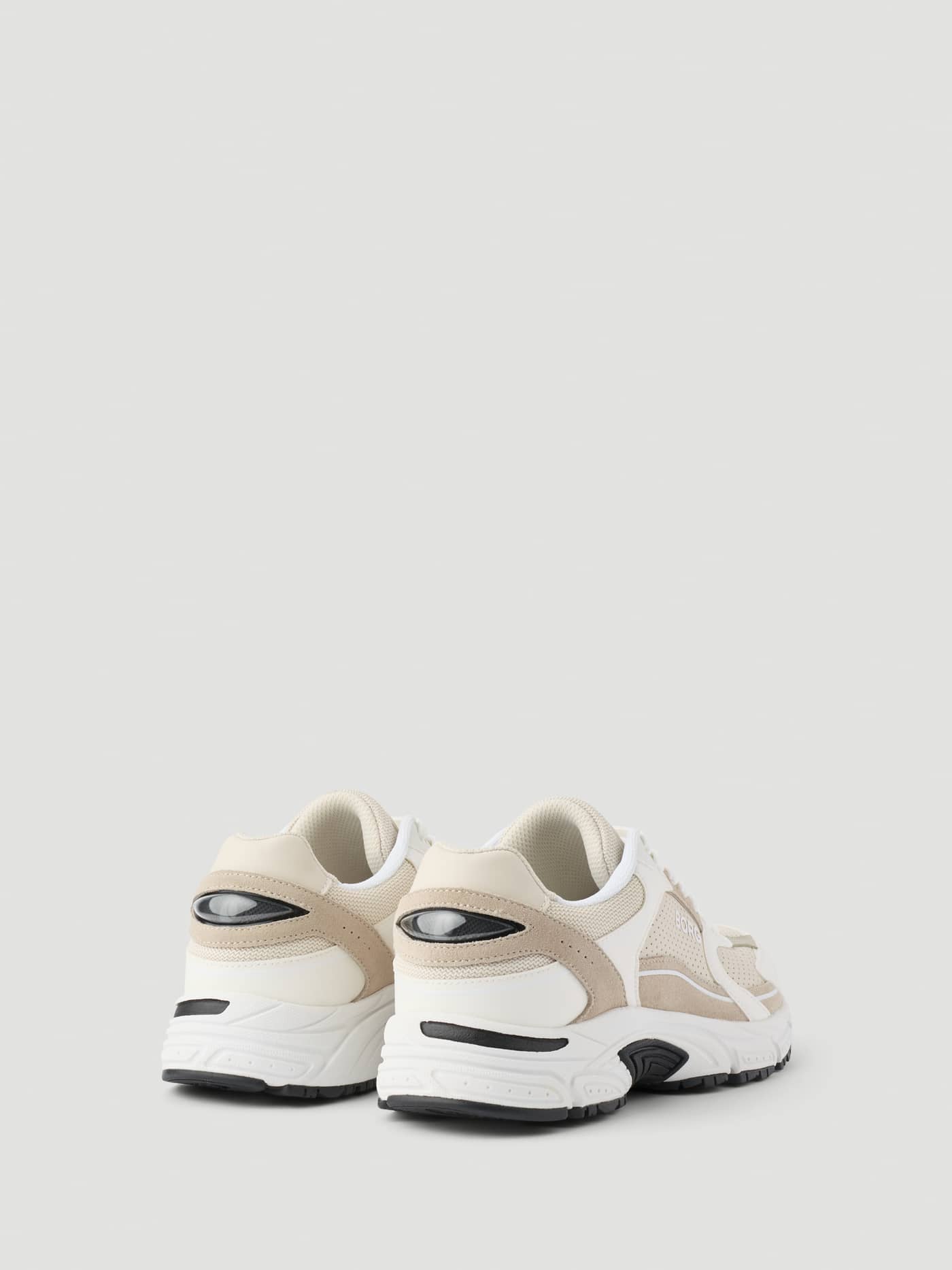 Back view of Women's Alley Sneakers in Beige, featuring a running-inspired design and a black logo on the heel. - Image 3