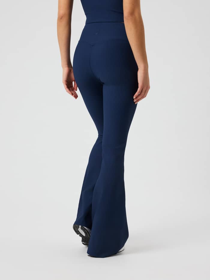 Back view of the Studio Ribbed Flare Tights Tall in Dress Blues (Blue) showing the flared leg and ribbed fabric.