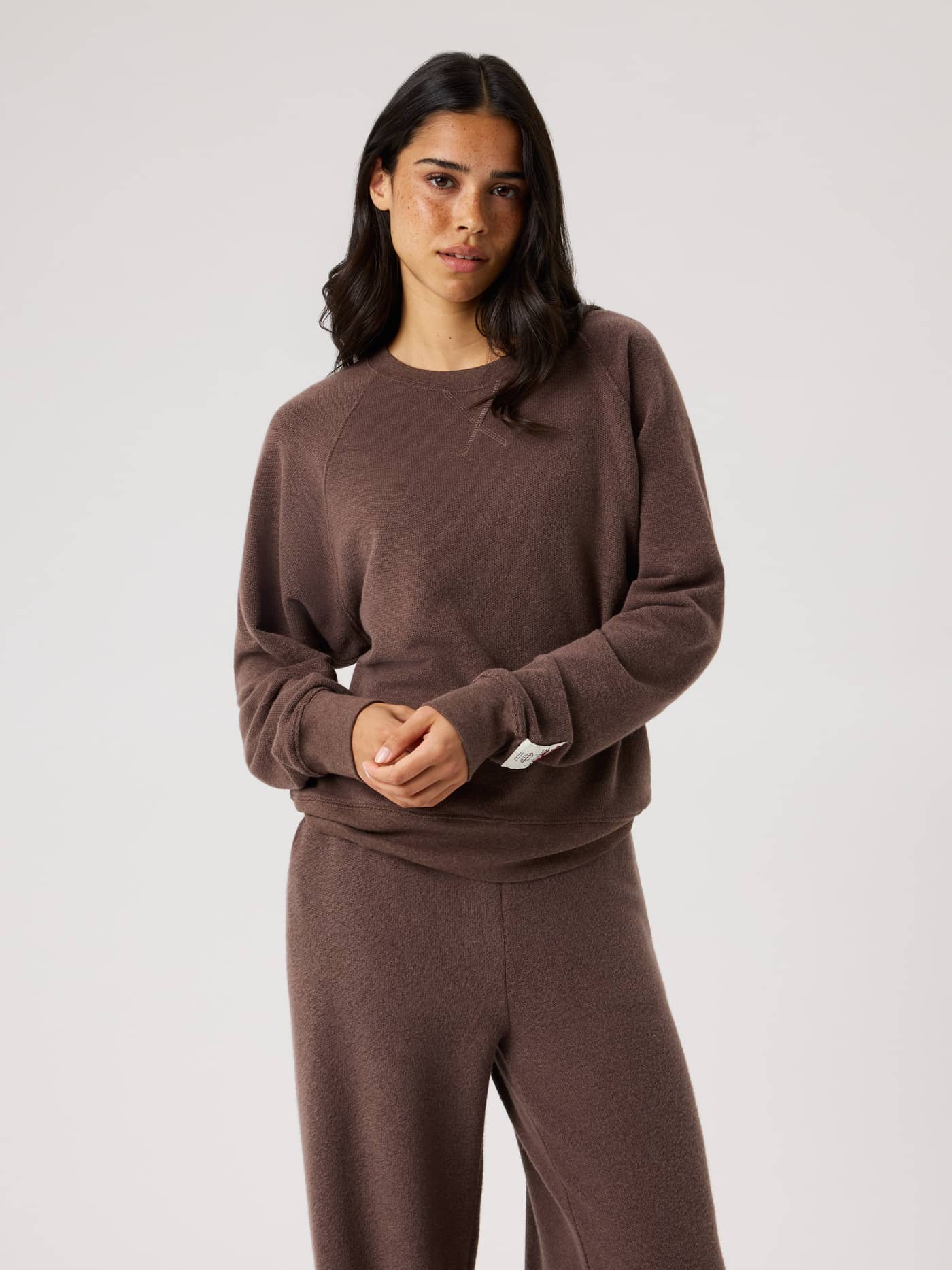 Front view of a model wearing the Studio French Terry Oversized Sweatshirt in Brown Melange (Brown) with a relaxed fit. - Image 2