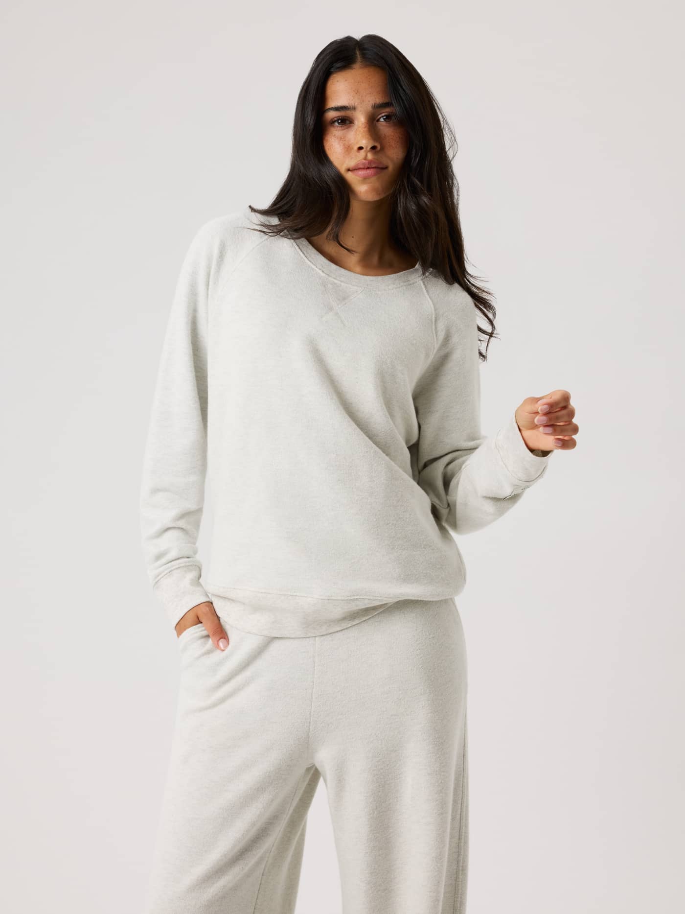 Front view of a model in the Björn Borg Studio French Terry Oversized Sweatshirt in Tofu Melange (Beige) with a relaxed fit. - Image 1