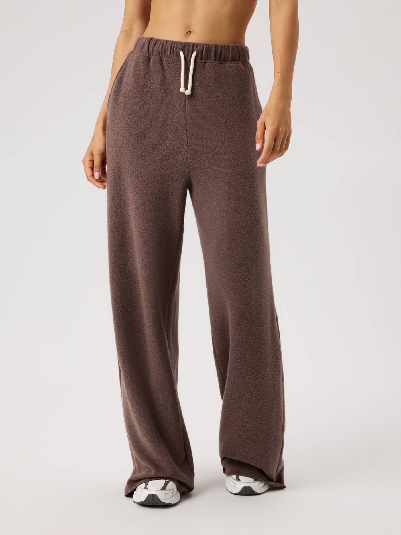 Front view of a model wearing Studio French Terry Oversized Sweatpants in Brown Melange (Brown) with a relaxed, soft fit. - Image 2